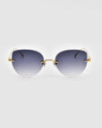 A pair of chic Fifi sunglasses from For Art's Sake®, featuring an elegant cat-eye frameless silhouette and 18k gold plating, is displayed against a plain white background. The modern design includes thin arms and minimalistic nose pads, exuding sophistication.