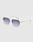 For Art's Sake® Rose Garden sunglasses feature gold frames and rectangular blue-tinted lenses on a white background, with temples showcasing a wavy design adorned with detailed sculpted rose ornaments near the hinges.