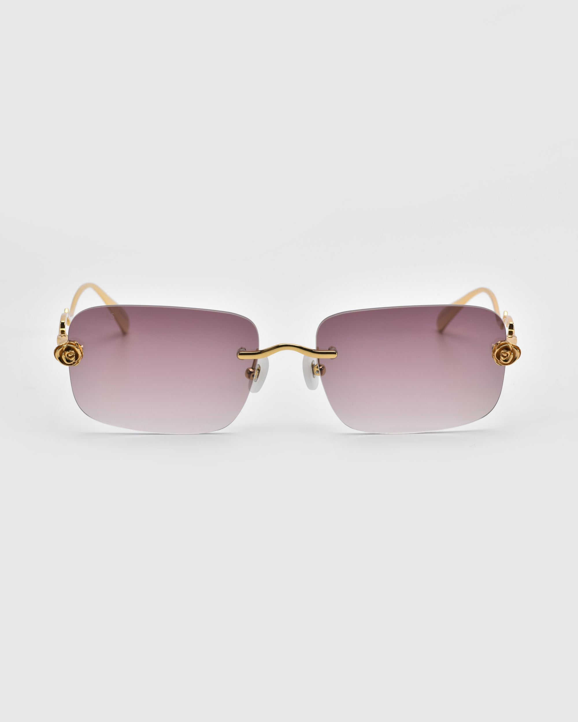 These oversized For Art's Sake® sunglasses from the Rose Garden collection have gradient lenses shifting from purple to clear, gold-tone temples and hinges, and sculpted rose ornaments for added elegance.