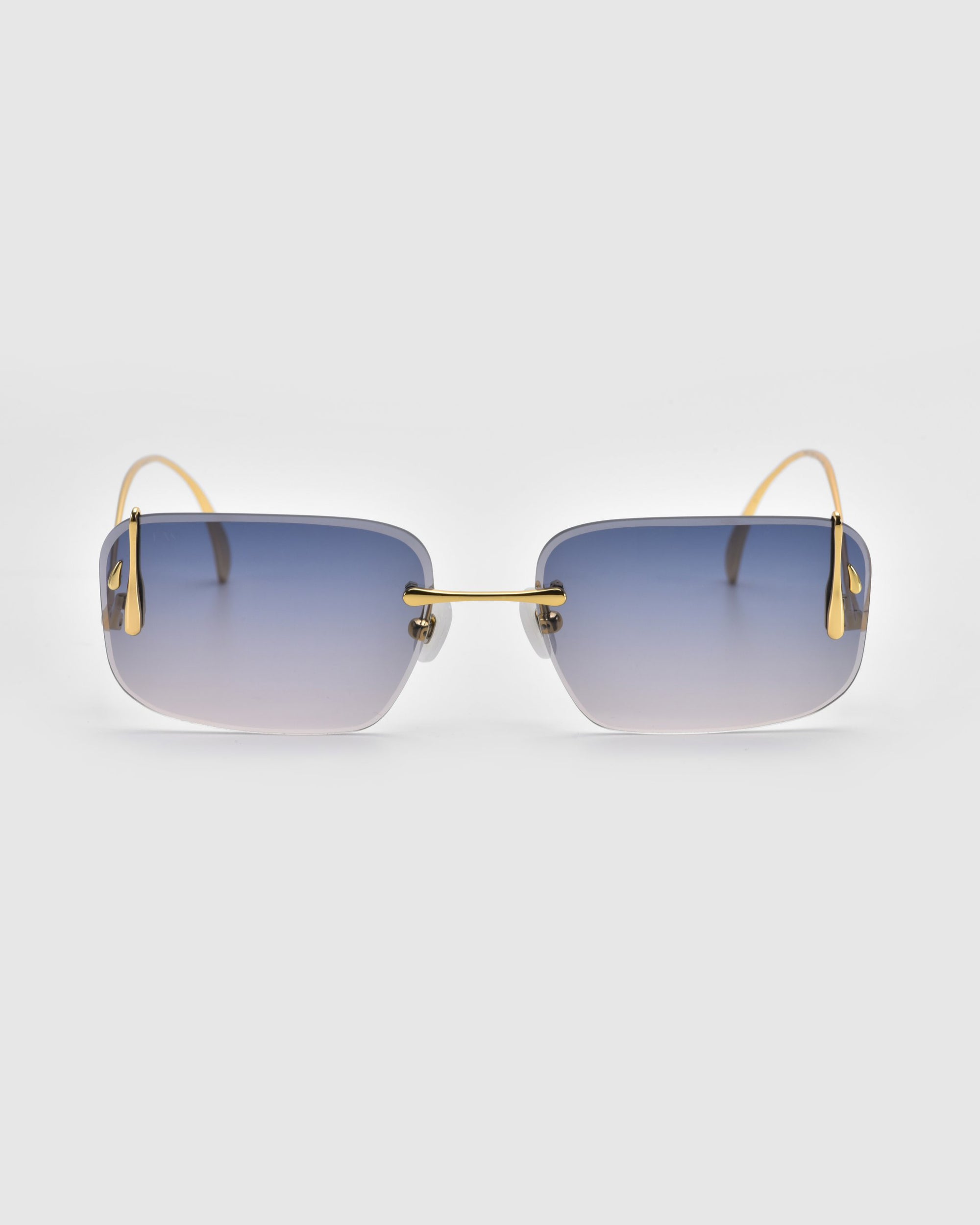 Vermilion by For Art's Sake®: Rectangular sunglasses with gradient blue lenses and thin gold-toned arms and bridge, showcasing artistic flair against a light gray background.