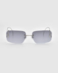 The Vermilion sunglasses by For Art's Sake® feature a sleek rimless design with rectangular grey lenses and thin metal arms. The lenses attach directly to sculptural temples, creating an elegant silhouette against a plain light grey background.