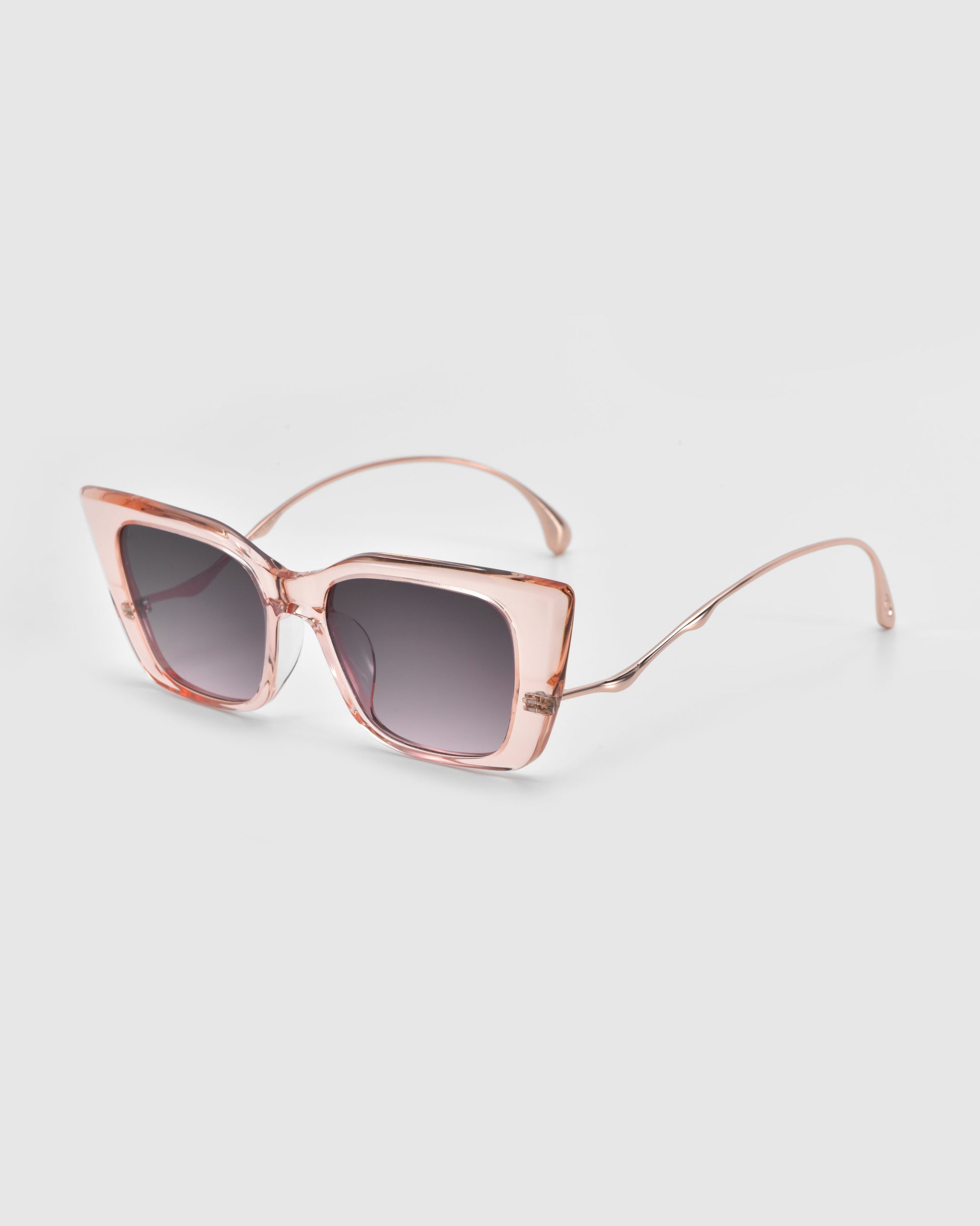 The Dusk sunglasses by For Art's Sake® feature a rose gold square design with transparent pink acetate frames, gradient lenses, thin curved arms, signature temples, and a modern oversized style. They are showcased on a light gray background.