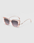 The Dusk sunglasses by For Art's Sake® feature a rose gold square design with transparent pink acetate frames, gradient lenses, thin curved arms, signature temples, and a modern oversized style. They are showcased on a light gray background.