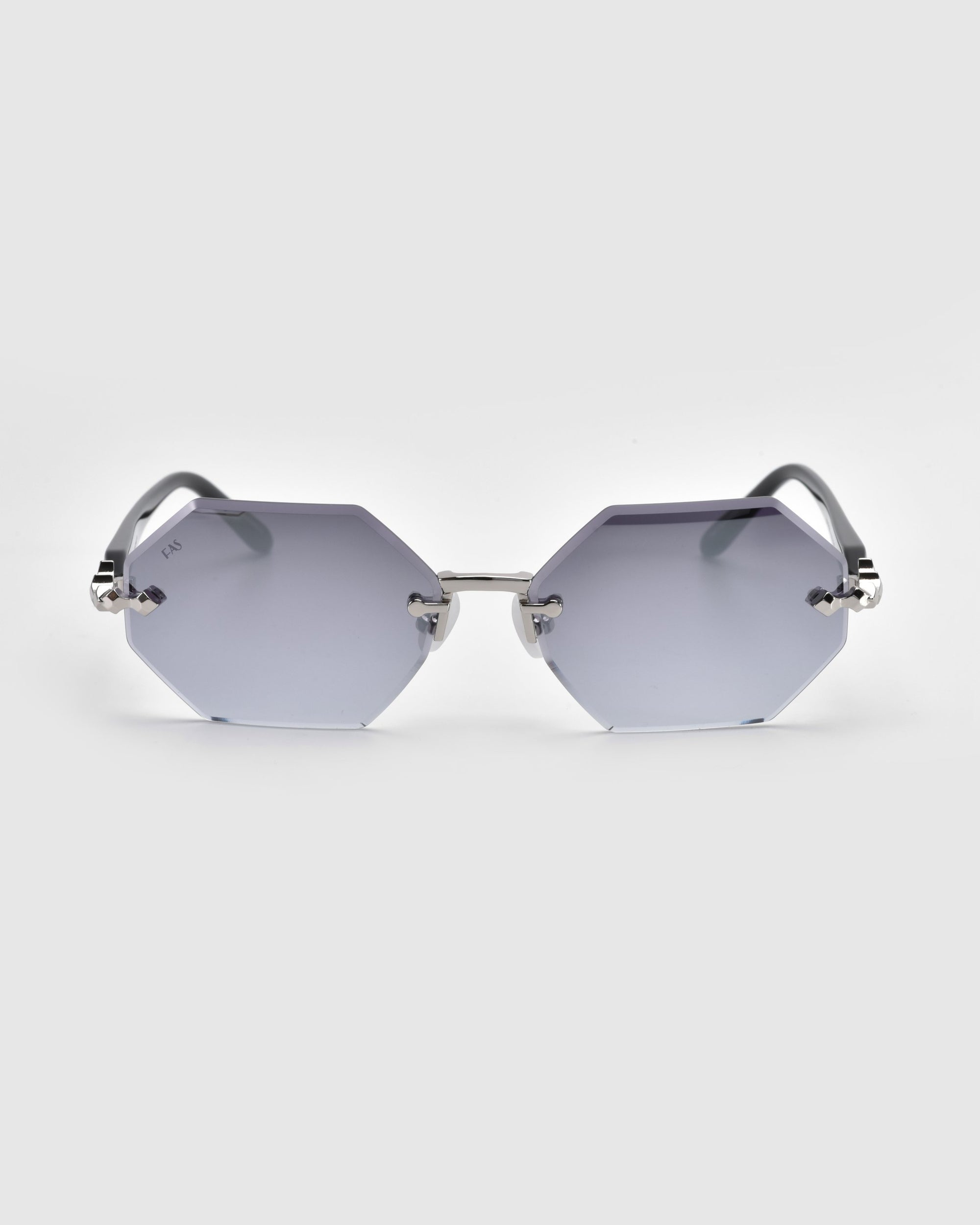 The Haze octagonal sunglasses from For Art's Sake®'s Rose Garden collection, featuring light gray lenses and thin metal arms, are showcased against a plain white background.