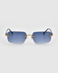 Part of the Rose Garden collection, Edith sunglasses by For Art's Sake® showcase stylish rimless design with blue rectangular lenses and gold accents on the nose bridge and temples, elegantly set against a plain white background.