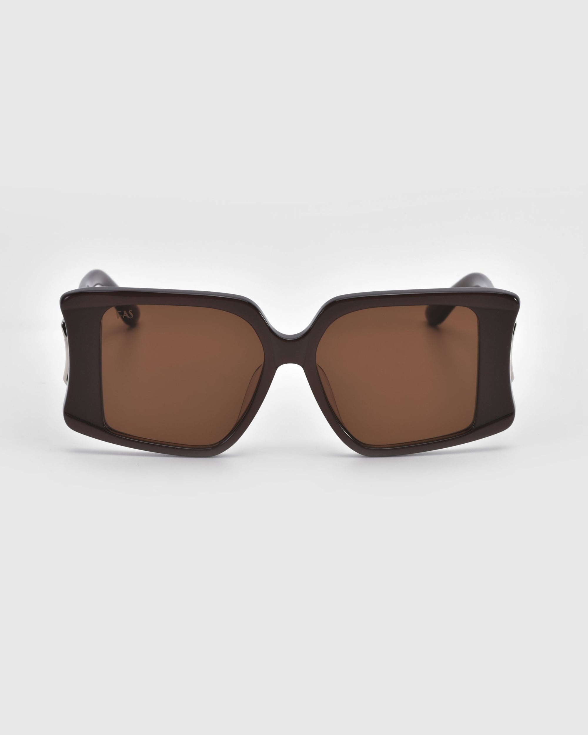 Bloom rectangular sunglasses by For Art's Sake®, featuring dark brown lenses and thick black frames, make a bold statement against the light gray background.