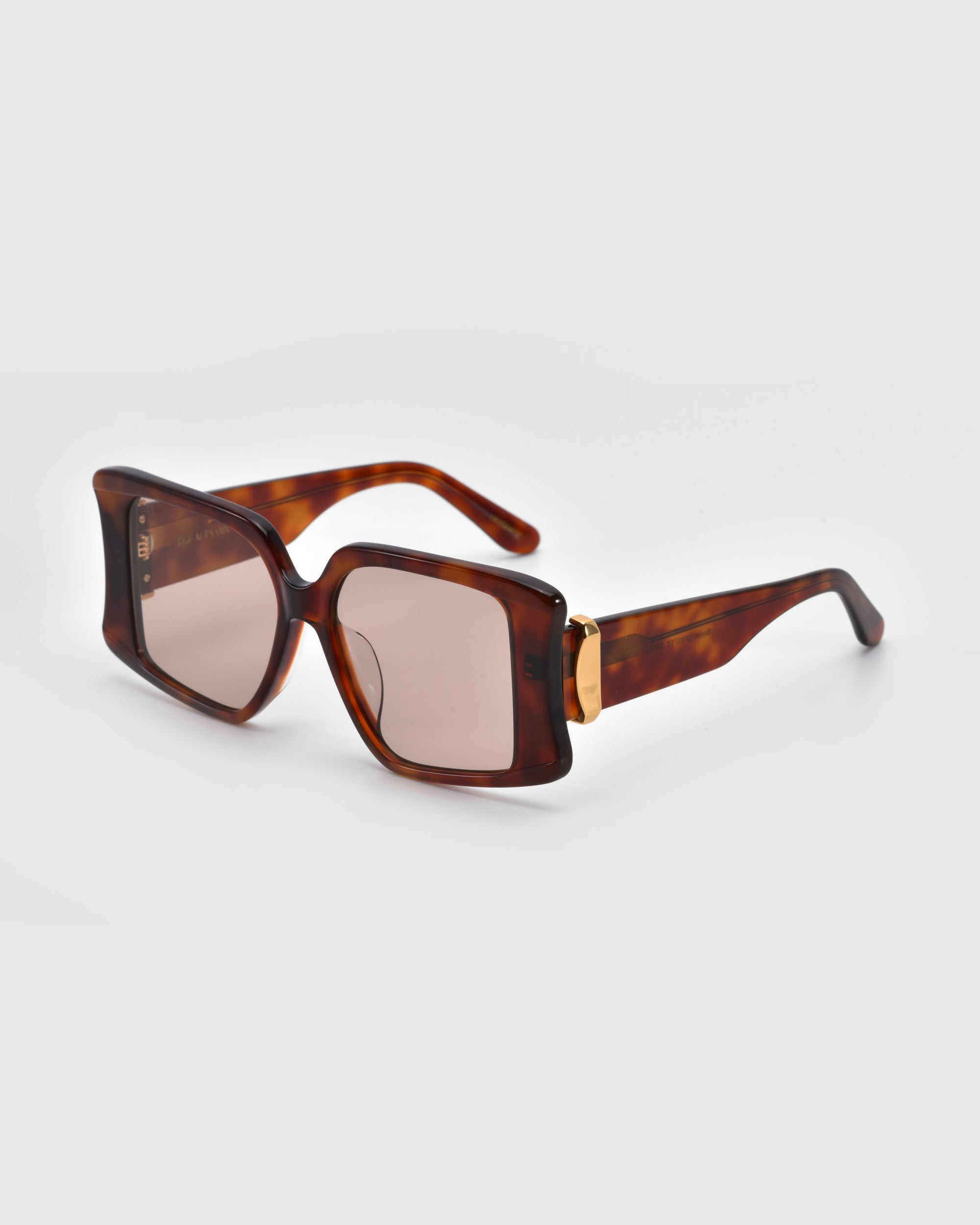 Bloom by For Art's Sake® are square sunglasses with tortoiseshell frames and brown lenses, elegantly displayed against a plain white background.