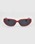 The Lush cat-eye sunglasses by For Art's Sake® feature red frames with dark lenses, crafted from premium materials, and are showcased against a plain white background.