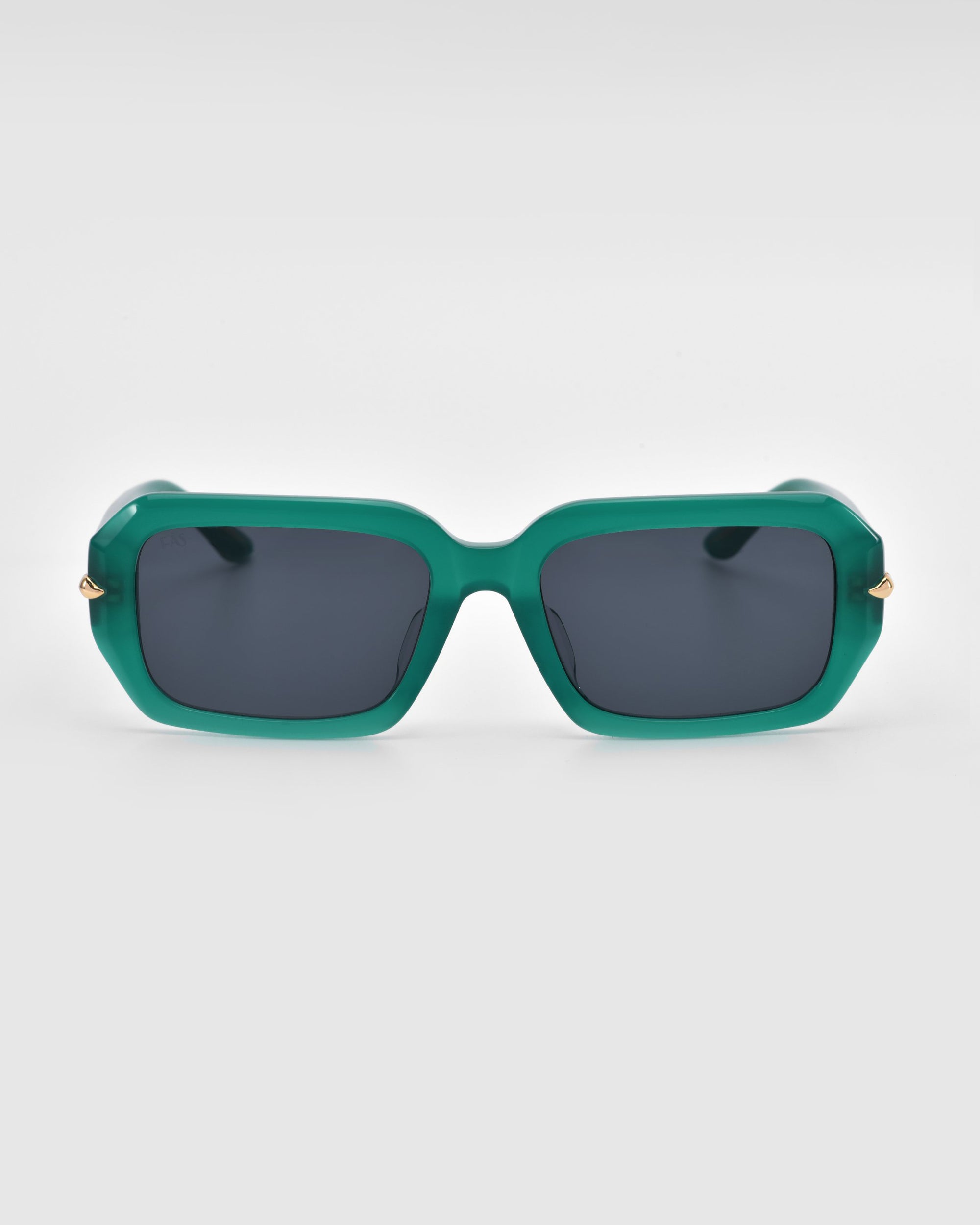 Fleur sunglasses by For Art's Sake® feature green square frames, dark lenses, and subtle gold accents on the acetate arms, showcased against a plain light background.