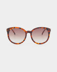 A pair of For Art's Sake® Scarlett sunglasses with a tortoiseshell patterned frame and round lenses. The ultralightweight shatter-resistant lenses are gradient tinted, transitioning from a darker shade at the top to a lighter shade at the bottom and offering 100% UVA & UVB protection. The background is plain white.