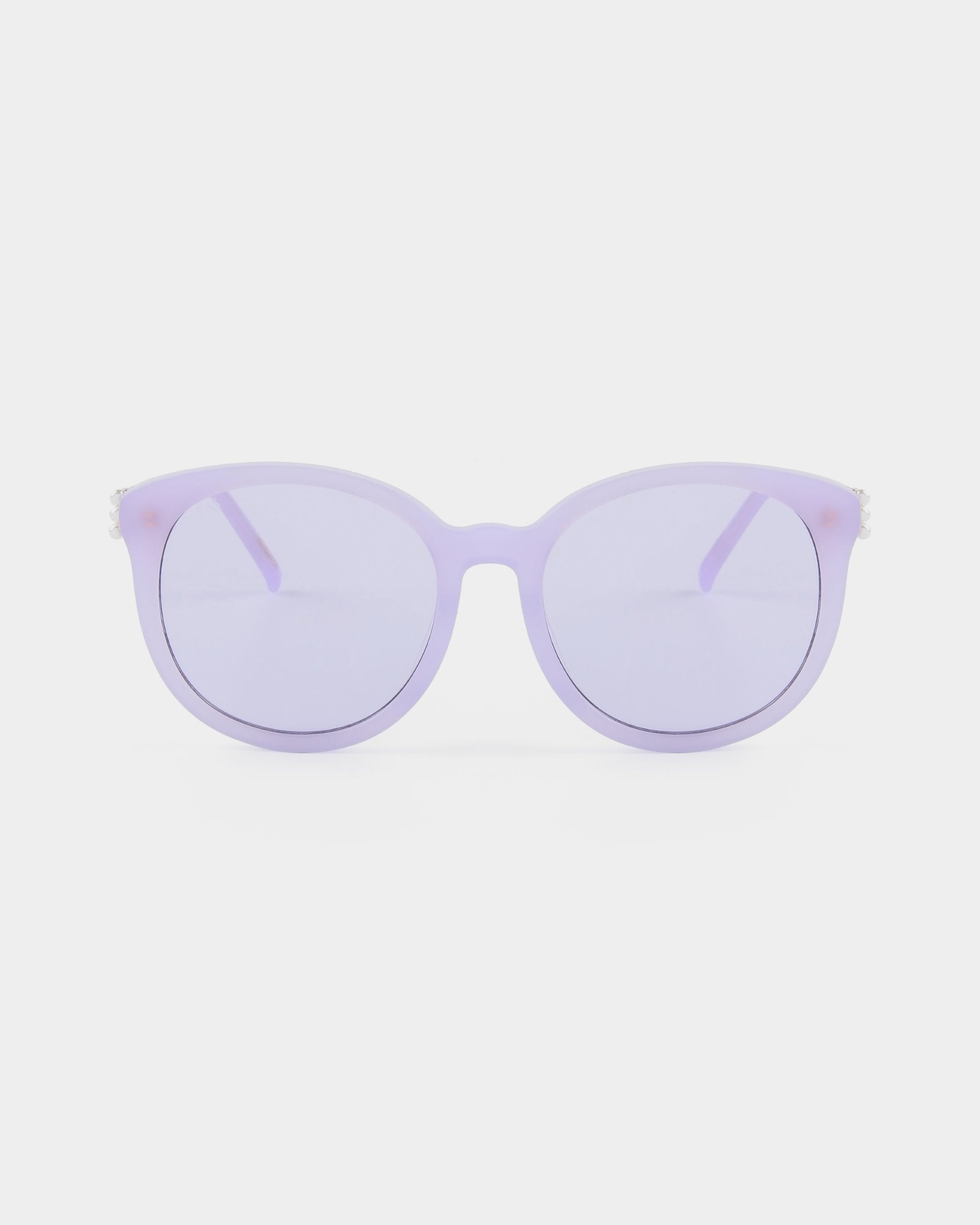 A pair of rounded lavender Scarlett sunglasses from For Art&#39;s Sake® with lightly tinted purple lenses against a white background. The frames are solid-colored, and the temples appear to be the same shade of lavender. Featuring ultralightweight shatter-resistant lenses, these sunglasses provide 100% UVA &amp; UVB protection.