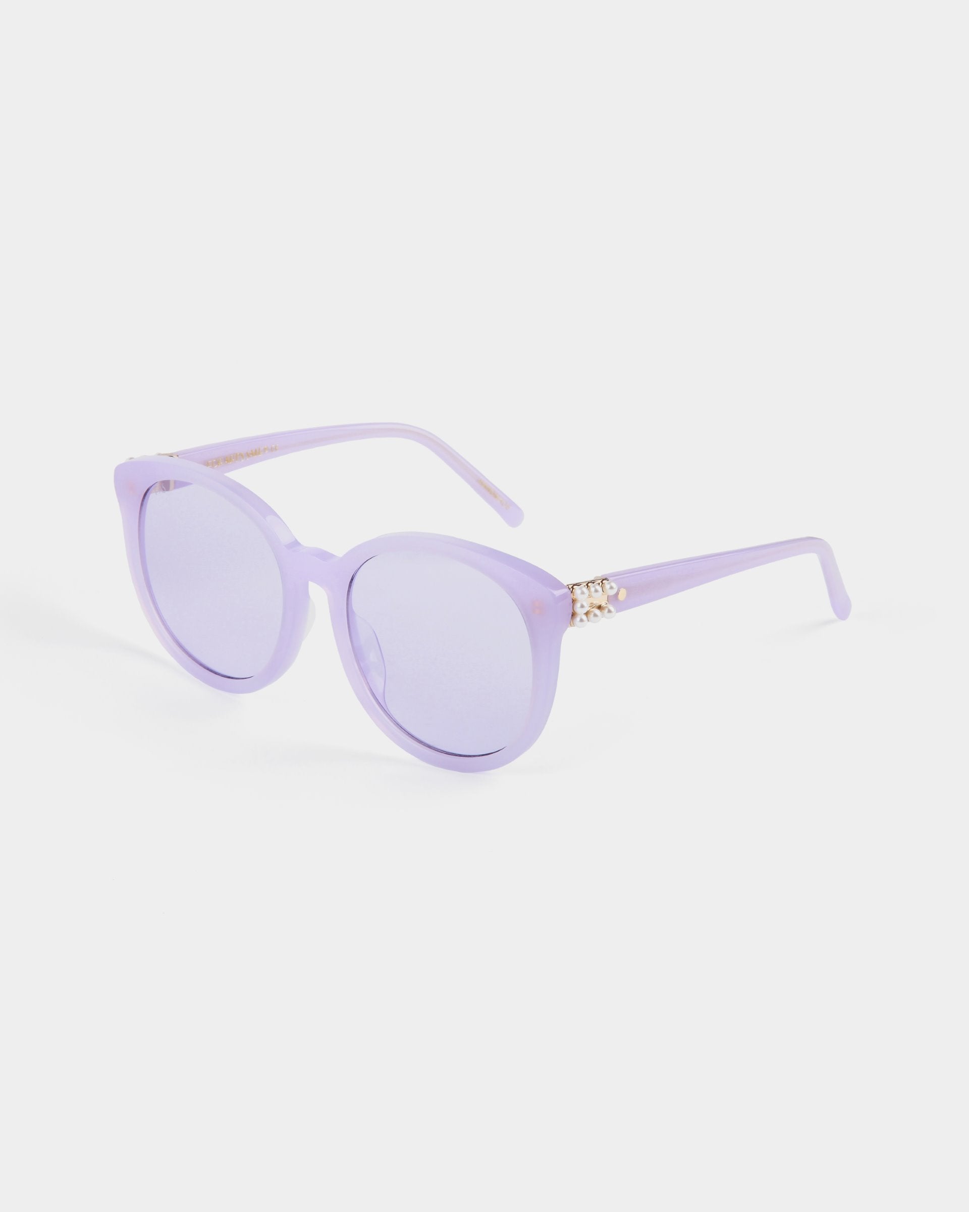 A pair of round lavender Scarlett frames with purple-tinted, shatter-resistant nylon lenses and gold accents on the temples from For Art&#39;s Sake®. The glasses feature UVA &amp; UVB-protected lenses and are positioned against a plain white background.