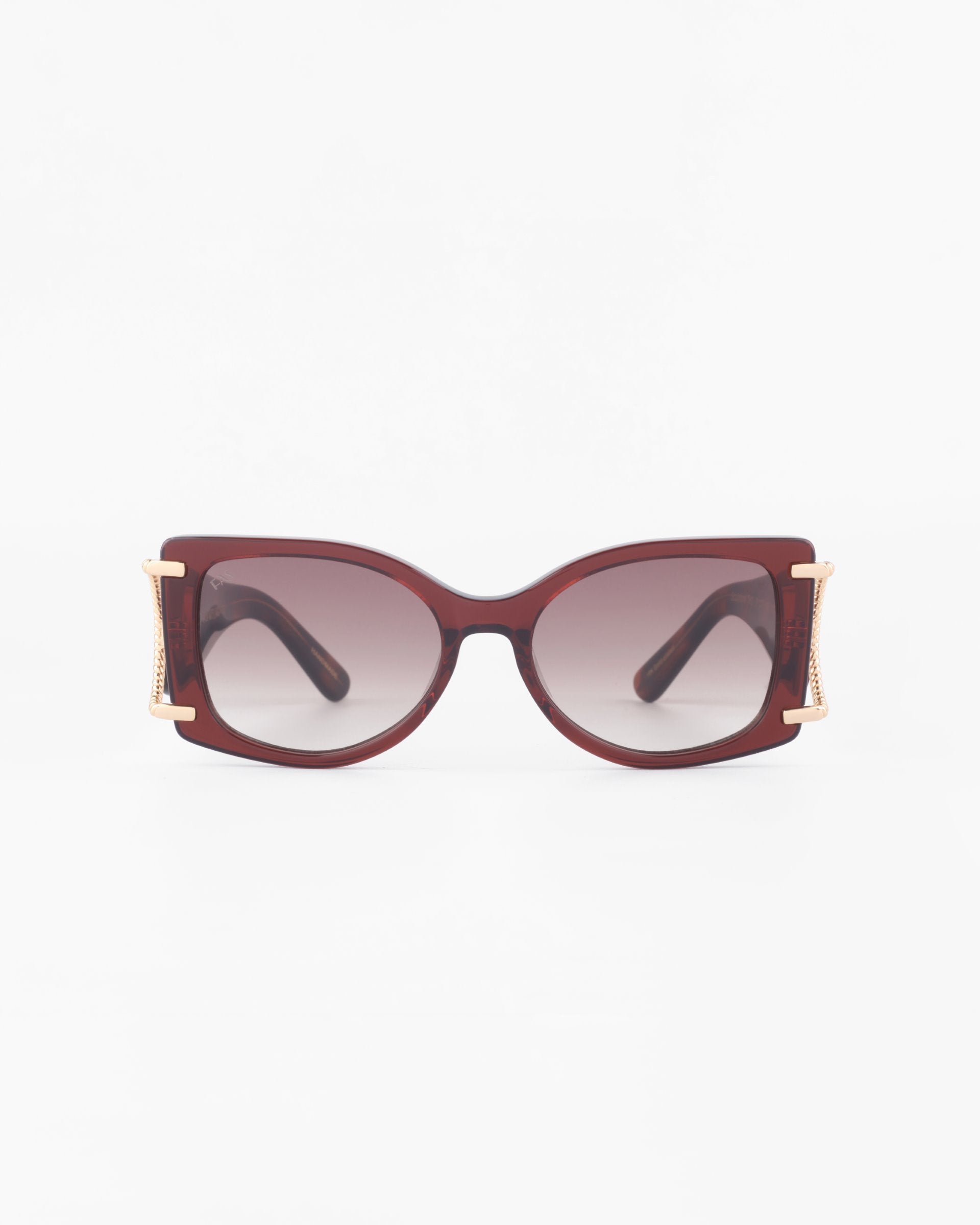A pair of stylish, oversized acetate sunglasses with dark gradient lenses, a maroon frame, and 18-karat gold-plated accents on the temples. Boasting 100% UVA &amp; UVB protection, the Sculpture glasses by For Art&#39;s Sake® are positioned against a white background, showing a frontal view.