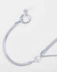 A close-up image of a modern silver Snake Glasses Chain from For Art's Sake® with a multi-strand snake chain design. The Snake Glasses Chain features a toggle clasp system, with one end circular and the other a bar. The sleek, shiny metal reflects light, emphasizing its elegant and contemporary style.