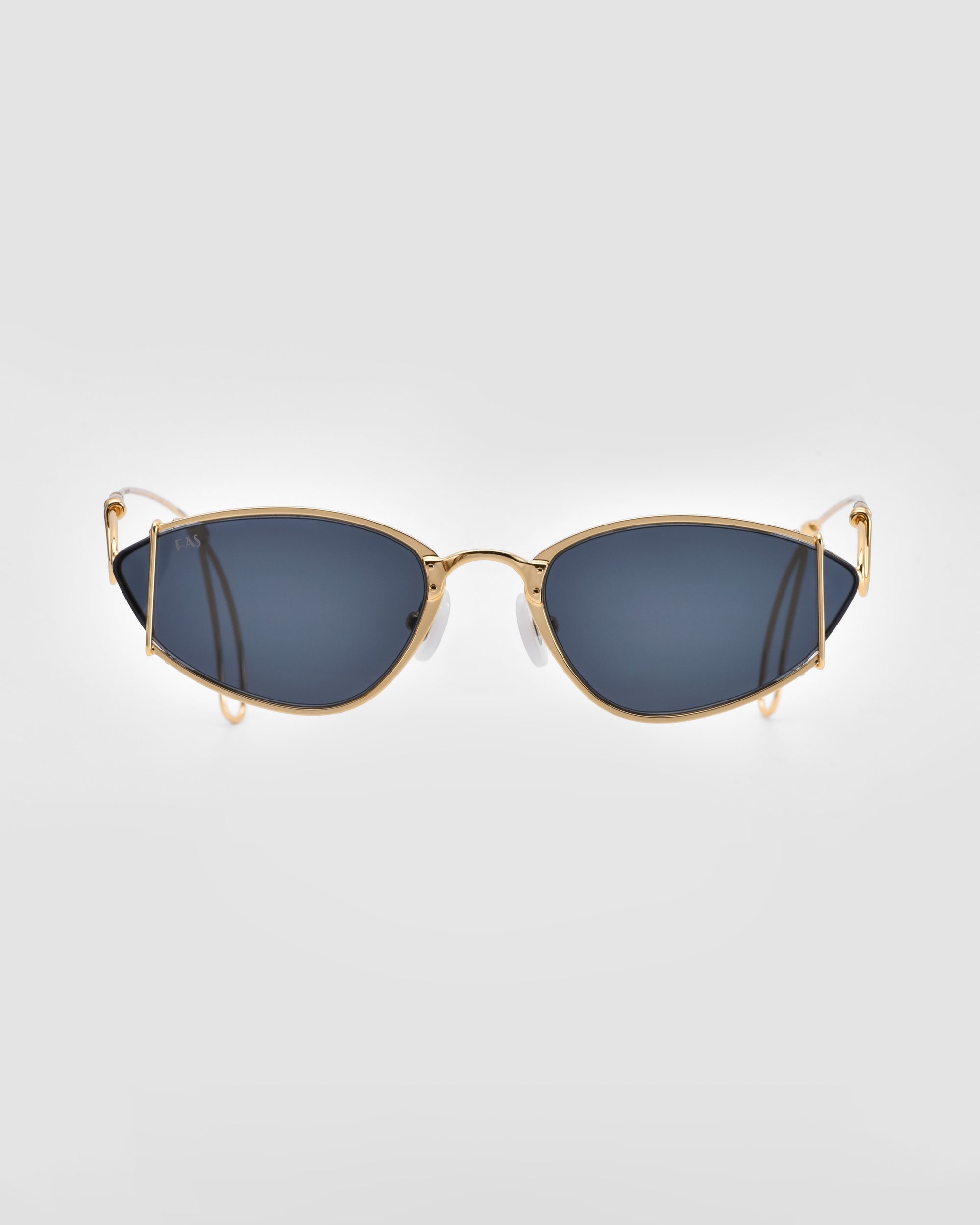 Introducing Ornate by For Art's Sake®: a pair of sleek, modern statement sunglasses featuring a slim, 18-karat gold-plated metal frame and dark lenses. The design includes slightly angled, cat-eye-shaped lenses and thin, curved temple arms. They offer 100% UVA & UVB protection and are displayed against a plain, light gray background.


