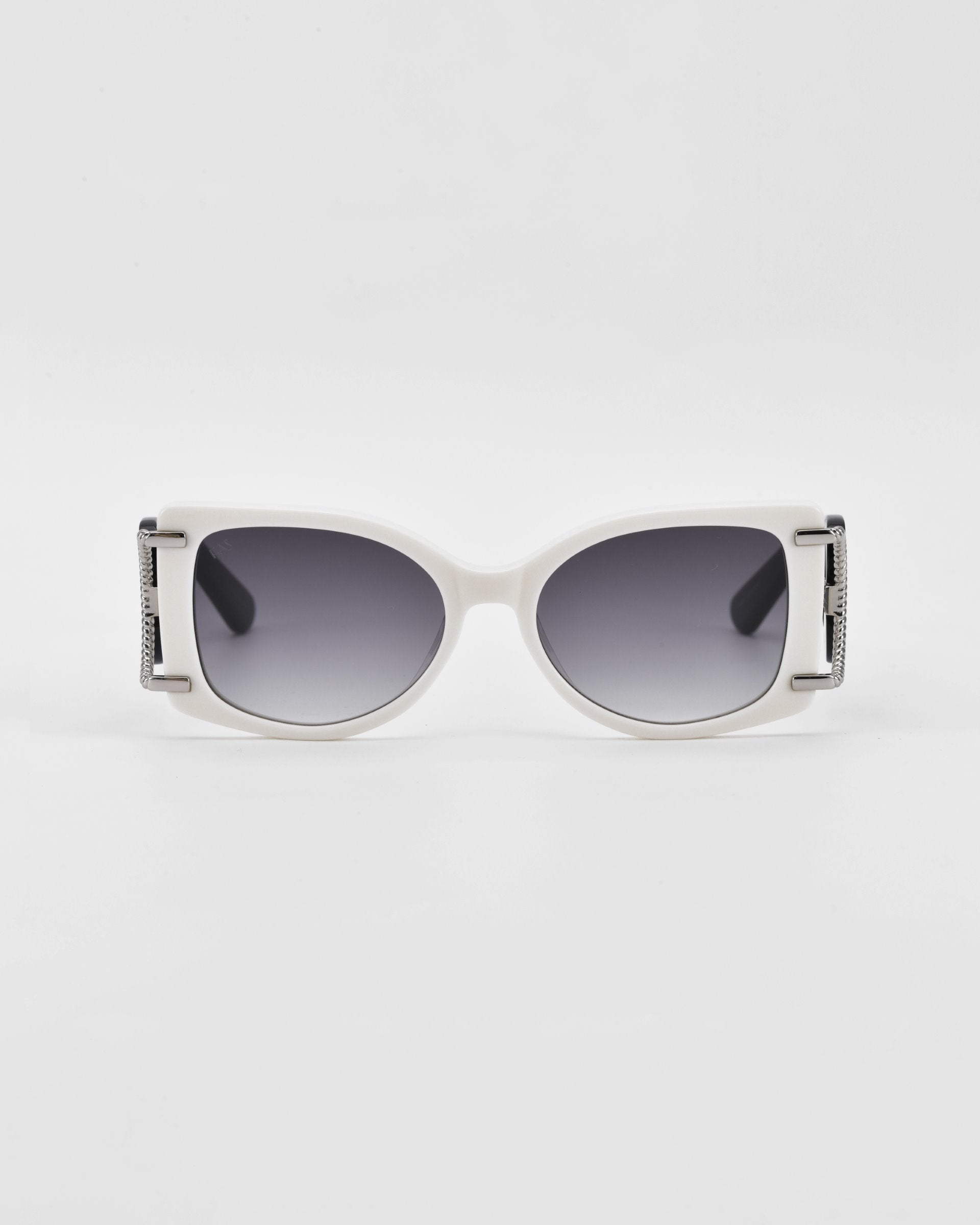 A pair of stylish acetate sunglasses featuring a white frame and dark-tinted lenses. The arms have 18-karat gold-plated hinge details with textured patterns, adding a touch of elegance to the overall design. These Sculpture by For Art&#39;s Sake® sunglasses offer 100% UVA &amp; UVB protection, set against a plain, white background.