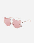 Stylish Teddy Pink sunglasses from For Art's Sake® with rose-tinted lenses shaped like bear heads and thin gold metal arms, providing ample UV protection against a plain white background.