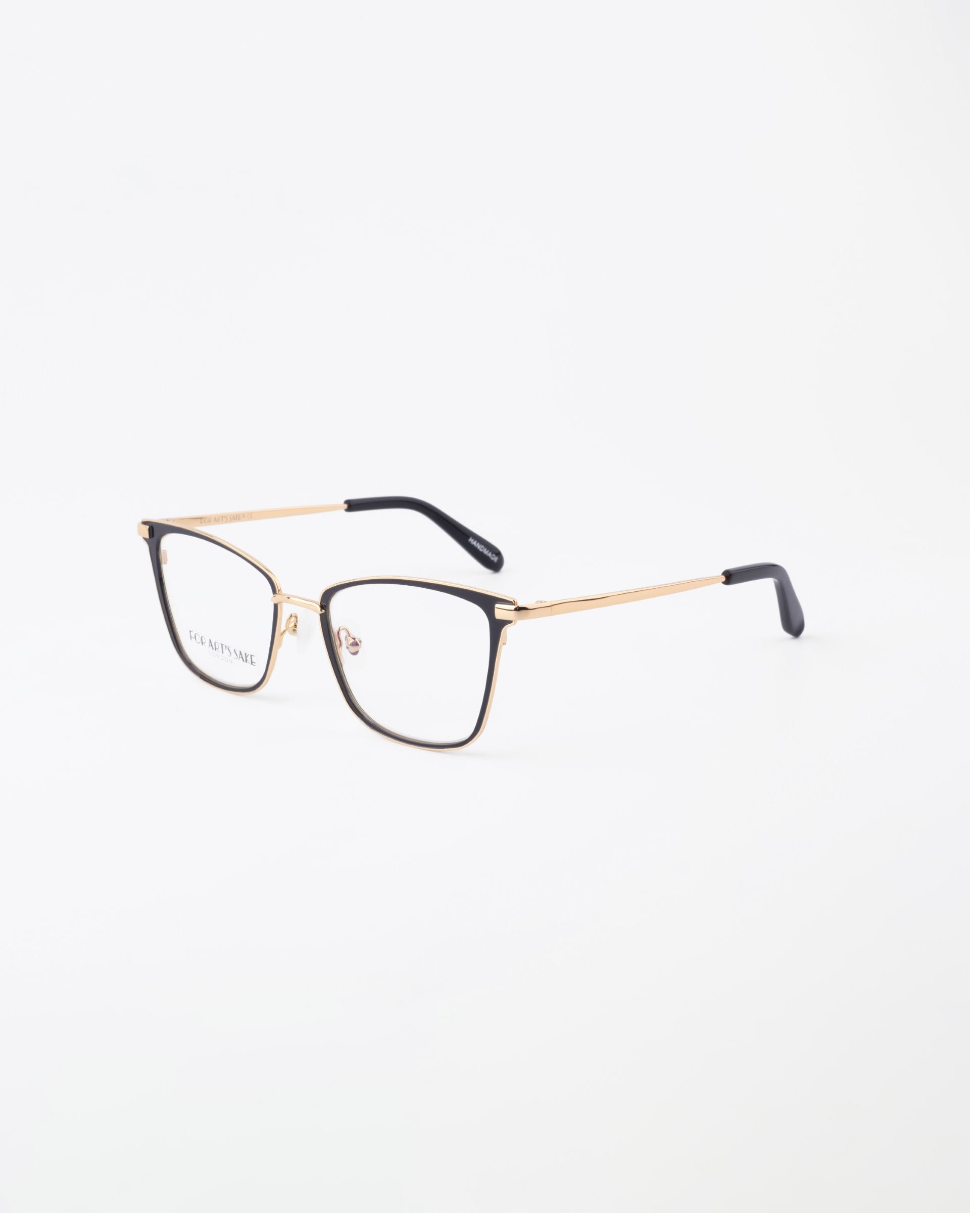 A pair of stylish For Art&#39;s Sake® Windsor eyeglasses with thin 18-karat gold-plated frames and black temple tips are set against a plain white background. The lenses, which feature a blue light filter, showcase the minimalist and elegant design of the eyewear.