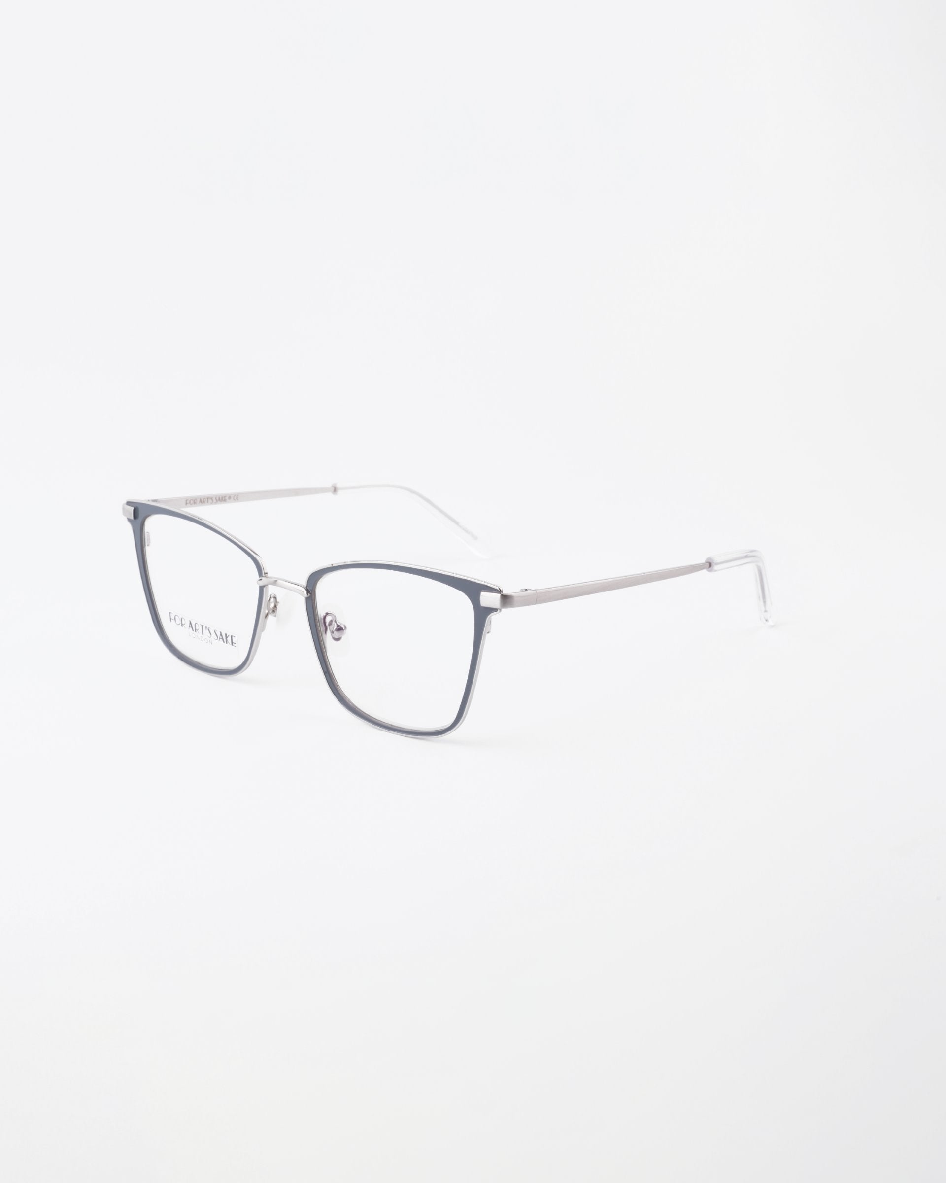 A pair of For Art&#39;s Sake® Windsor eyeglasses with a sleek design. The frame is mostly rimless on the bottom, with metallic arms and a thin bridge connecting the lenses. The temples are straight with a transparent section at the tips. The lenses are clear and feature a blue light filter for added protection.