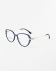 A pair of Waterhouse eyeglasses by For Art's Sake® with rounded grayish-blue frames, thin 18-karat gold-plated temples, and black ear tips. The glasses have clear prescription lenses and are positioned on a white background.