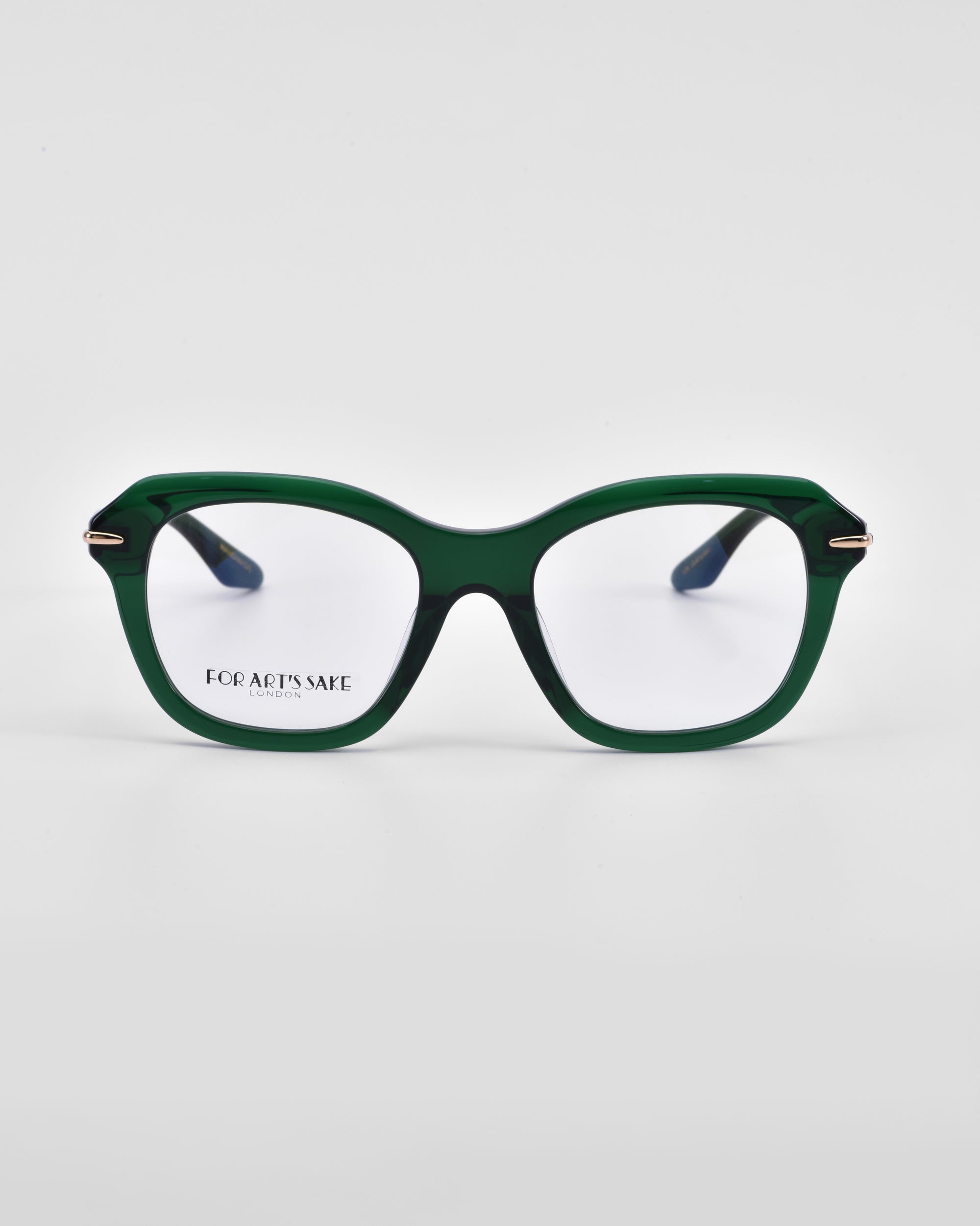 A pair of green, square-framed eyeglasses with subtle 18-karat gold plating on the hinges. The lenses are clear, and the product name &quot;Helene&quot; and brand name &quot;For Art&#39;s Sake®&quot; are visible on the inside of the left lens. The background is white.