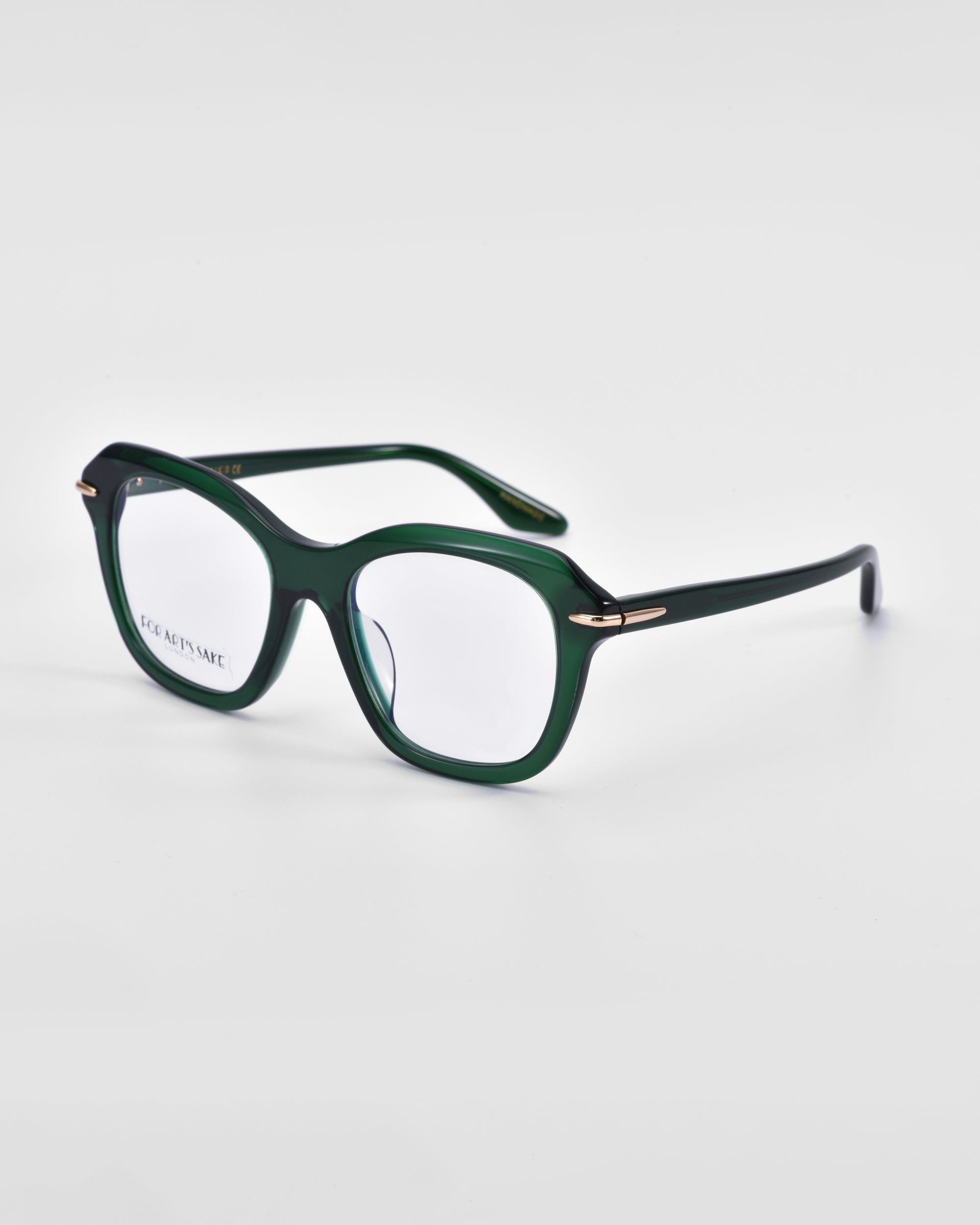 A pair of stylish green rectangular eyeglasses with a glossy finish, featuring 18-karat gold plating near the hinges. The For Art&#39;s Sake® Helene frames are sturdy with a slight curve in the arms, while the clear lenses rest on a plain white background.