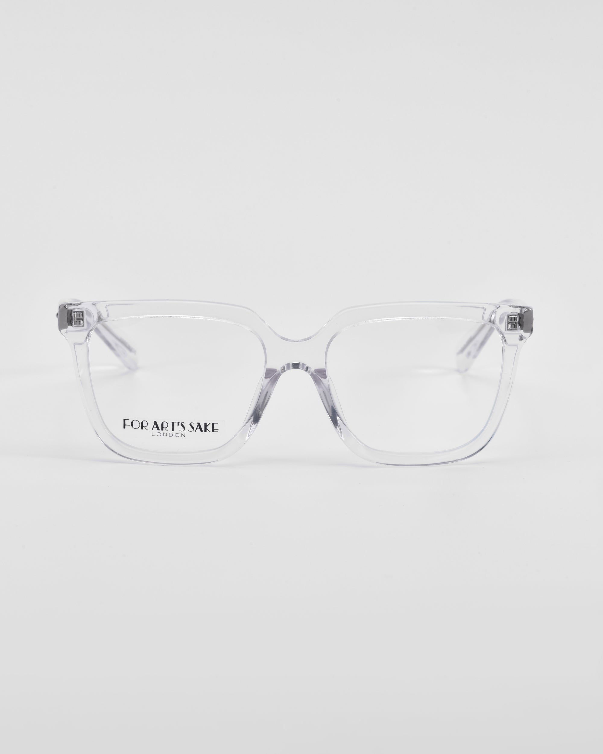 A pair of rectangular, clear-framed eyeglasses with thin arms and transparent lenses is placed against a plain white background. The brand name &quot;For Art&#39;s Sake®&quot; is visible on the left lens, showcasing a classic square silhouette perfect for prescription service.