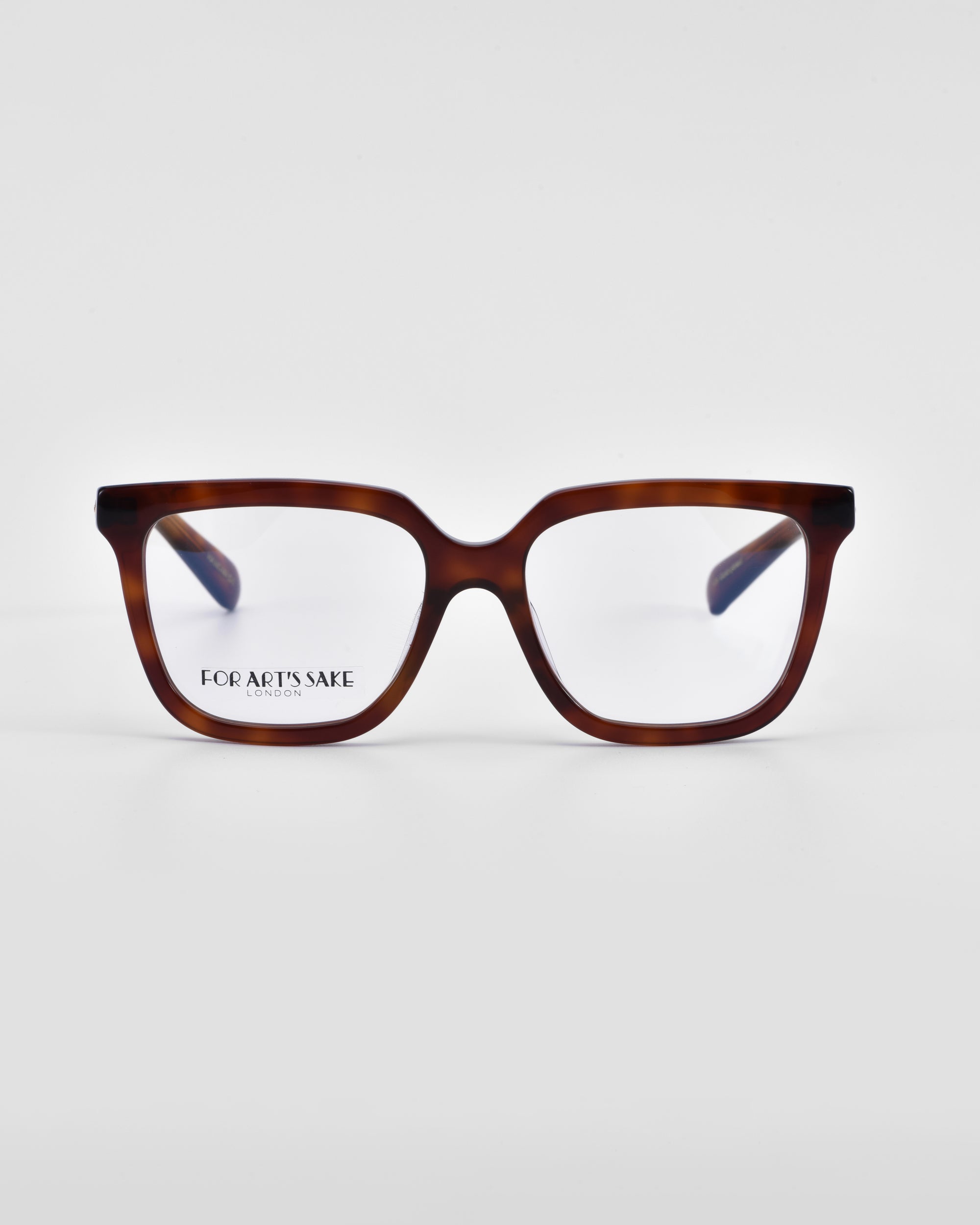 A pair of tortoiseshell eyeglasses with a classic square silhouette on a plain white background. The glasses have clear lenses, and the brand name &quot;For Art&#39;s Sake®&quot; is visible on the left lens, offering an elegant option for those seeking a prescription service. The product name is Nina.