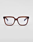 A pair of tortoiseshell eyeglasses with a classic square silhouette on a plain white background. The glasses have clear lenses, and the brand name "For Art's Sake®" is visible on the left lens, offering an elegant option for those seeking a prescription service. The product name is Nina.