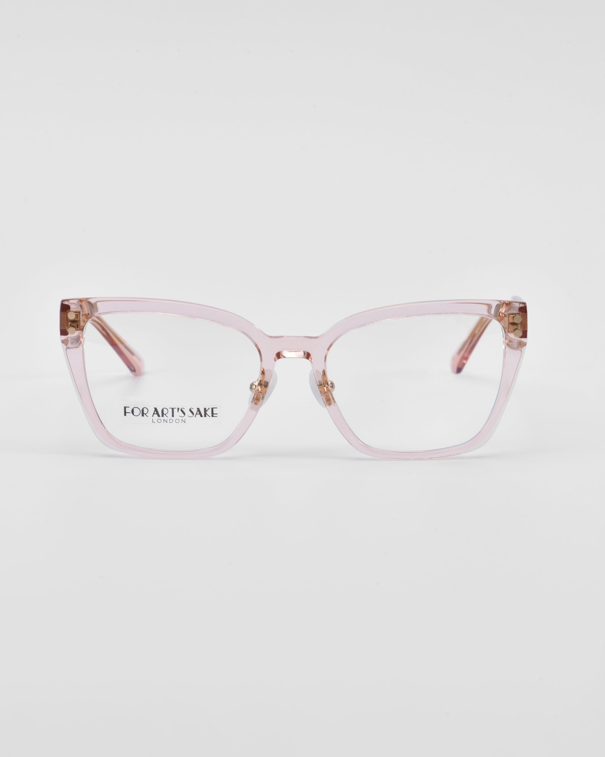 A pair of pink-colored Abbey cat-eye opticals with a transparent frame. The brand name &quot;For Art&#39;s Sake®&quot; is visible on the left lens. The background is plain white.