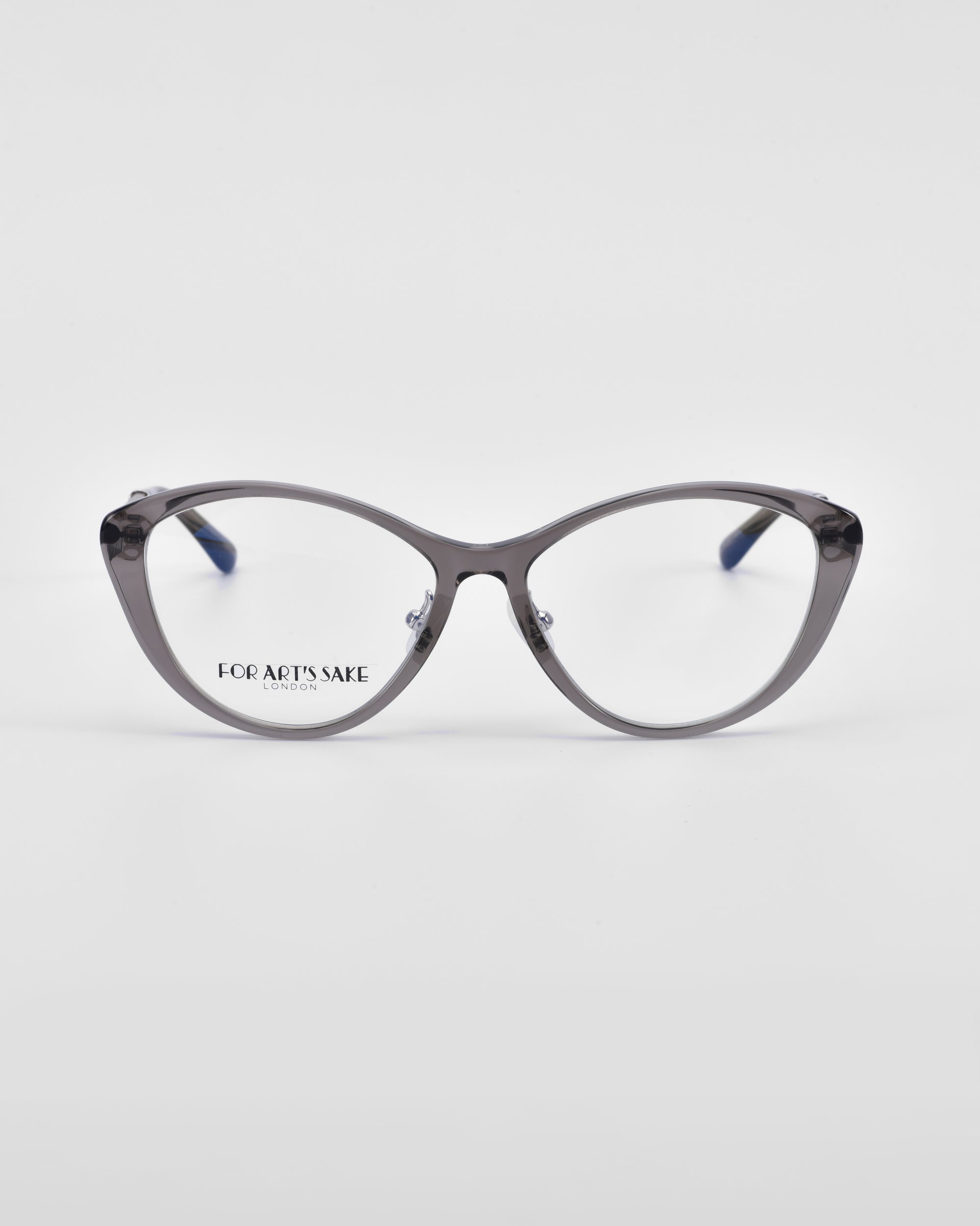 A pair of gray-framed eyeglasses with a cat-eye design, featuring 18-karat gold plating and the brand &quot;For Art&#39;s Sake®&quot; inscribed on one lens, is centered against a plain white background. The model is called Perla II.