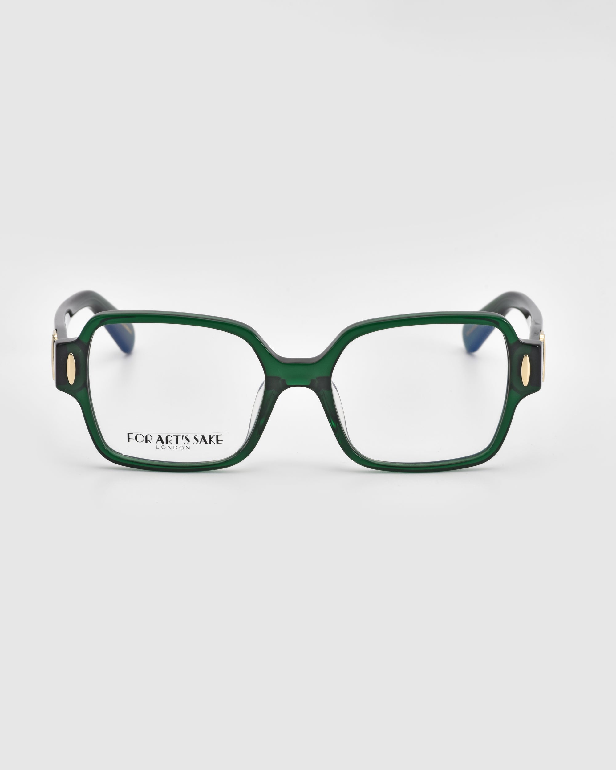 A pair of Hart square green eyeglasses with thick frames and gold accents on the temples from the For Art&#39;s Sake® brand. The classic design by For Art&#39;s Sake® is visible on the left lens. The lightweight glasses are set against a plain white background, combining elegance and comfort.