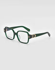 A pair of Hart eyeglasses by For Art's Sake® features green rectangular frames with thick borders, adorned with a "D" logo on the temples. The clear lenses have a subtle reflection, highlighting their pristine surface. Showcasing a classic design, these glasses are set against a white background and angled slightly to the left.