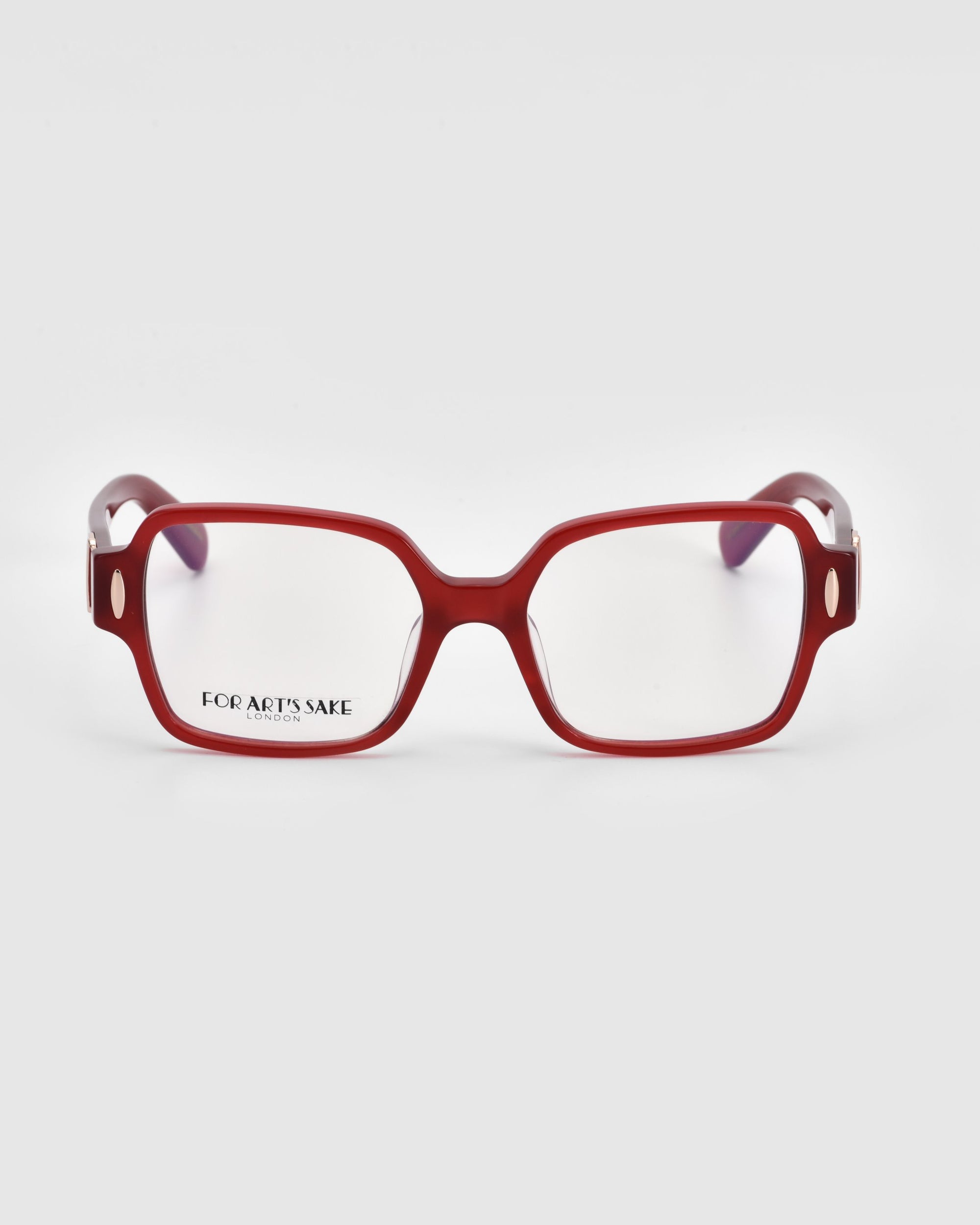 A pair of eyeglasses with a bold, rectangular red frame. The lenses are clear, and the arms of the glasses are red with a transparent section near the hinges. The brand name "For Art's Sake®" is visible on the inside of the left lens, showcasing their classic Hart design.