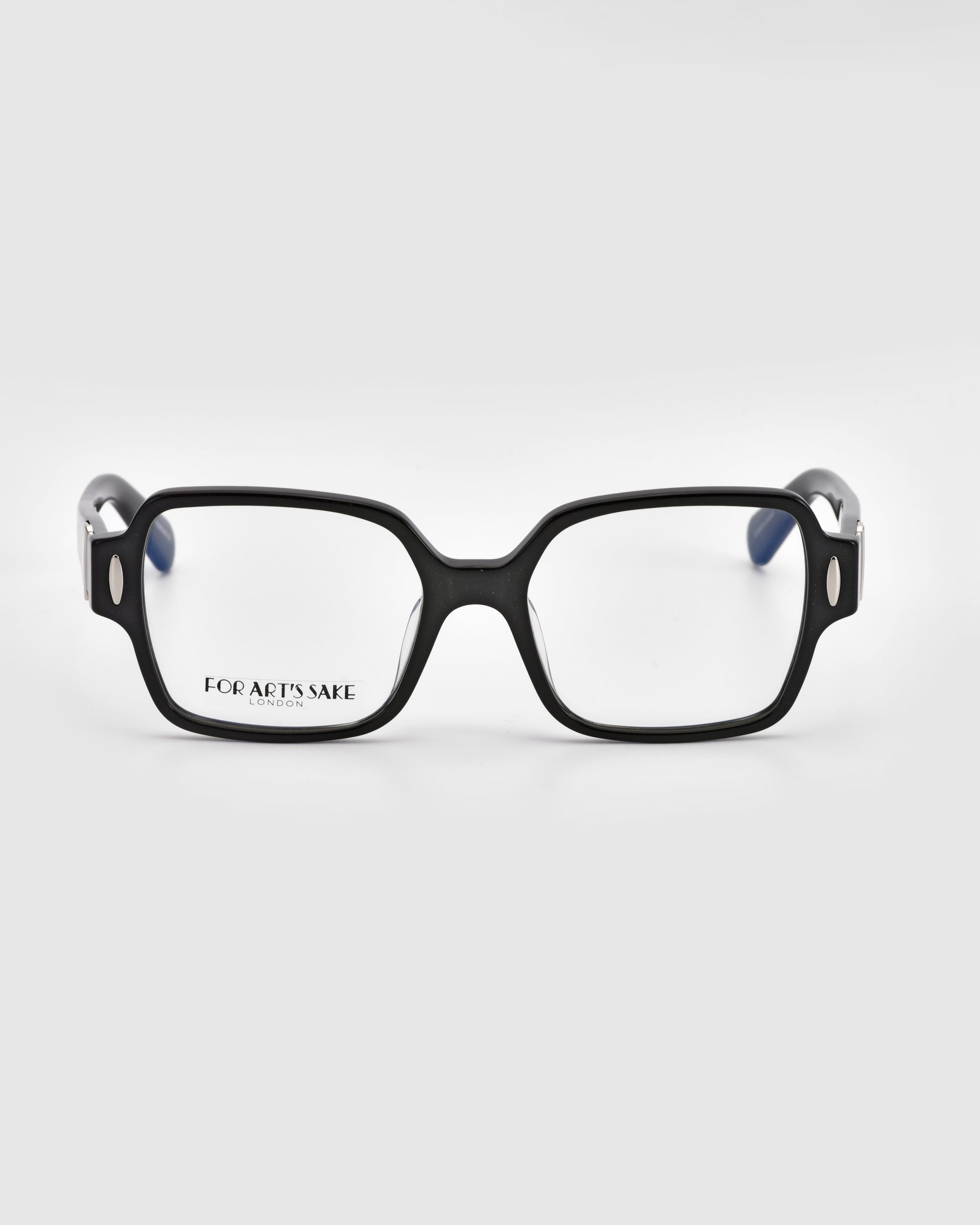 A pair of Hart rectangular black-rimmed eyeglasses from For Art's Sake®, featuring "FOR ART'S SAKE" on the left lens, displayed against a plain white background. The classic design of these versatile glasses is complemented by silver accents on the sides of the frames.