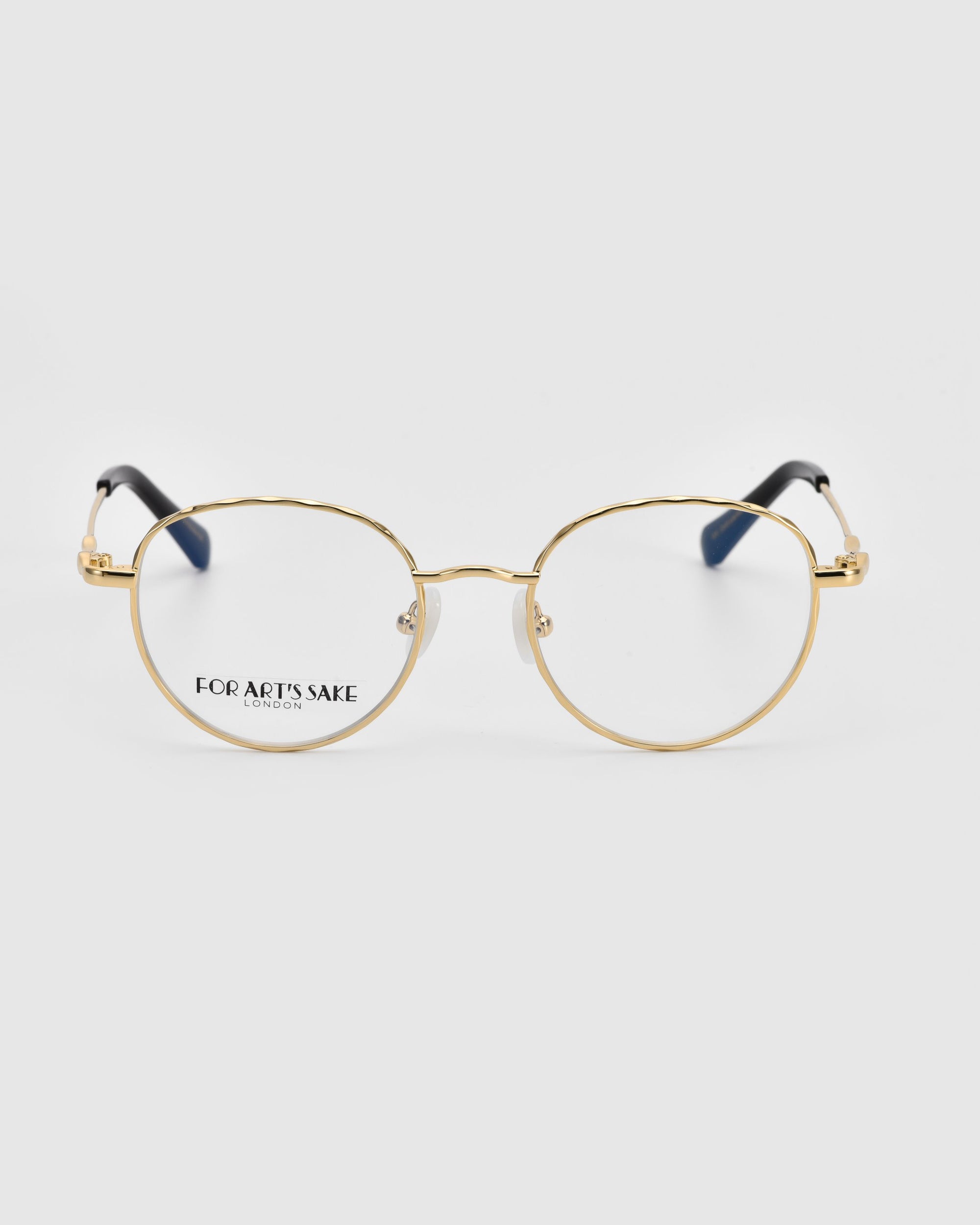 A pair of Bone I gold-rimmed round glasses with sleek round lenses, thin frames, and clear lenses. The text "For Art's Sake® LONDON" is visible on one of the luxurious metal detailing.