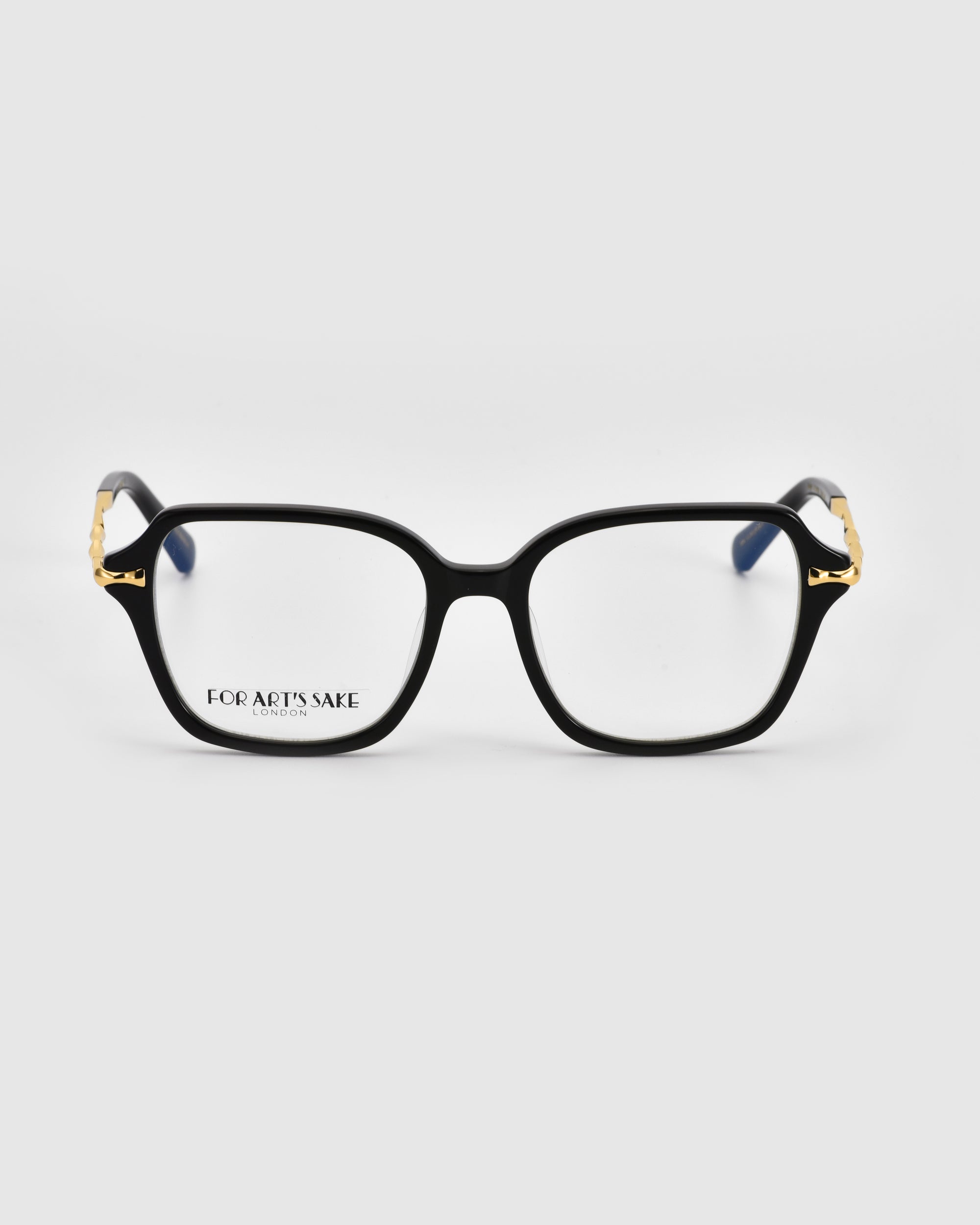 A pair of Delight black square eyeglasses with clear lenses exude modern sophistication. The temples feature small, gold decorative details near the hinges, adding a touch of vintage charm. The brand name "For Art's Sake®" is printed on the left lens against a plain white background.