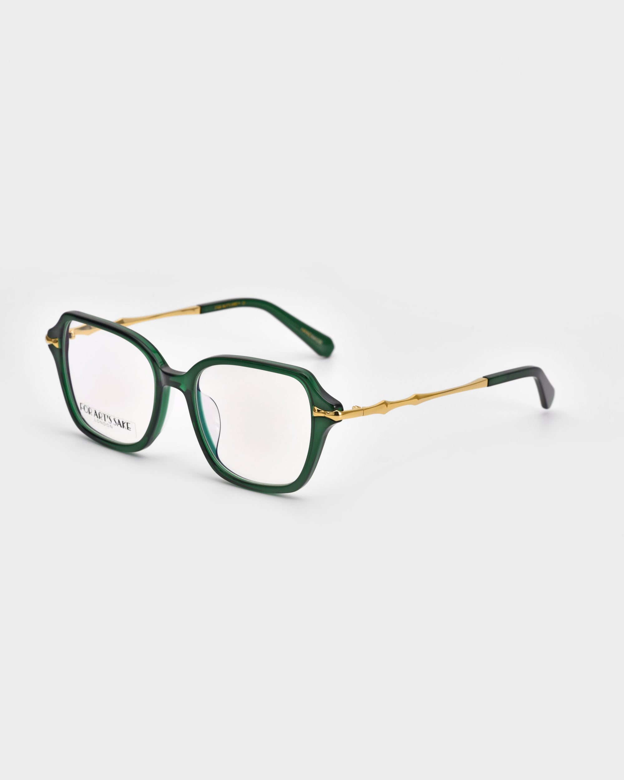 The Delight by For Art&#39;s Sake® are a pair of stylish square eyeglasses with a dark green, square-shaped frame and gold-toned temples featuring unique details. The arms have black tips. The lenses are clear, and the overall design marries modern sophistication with a touch of vintage charm.