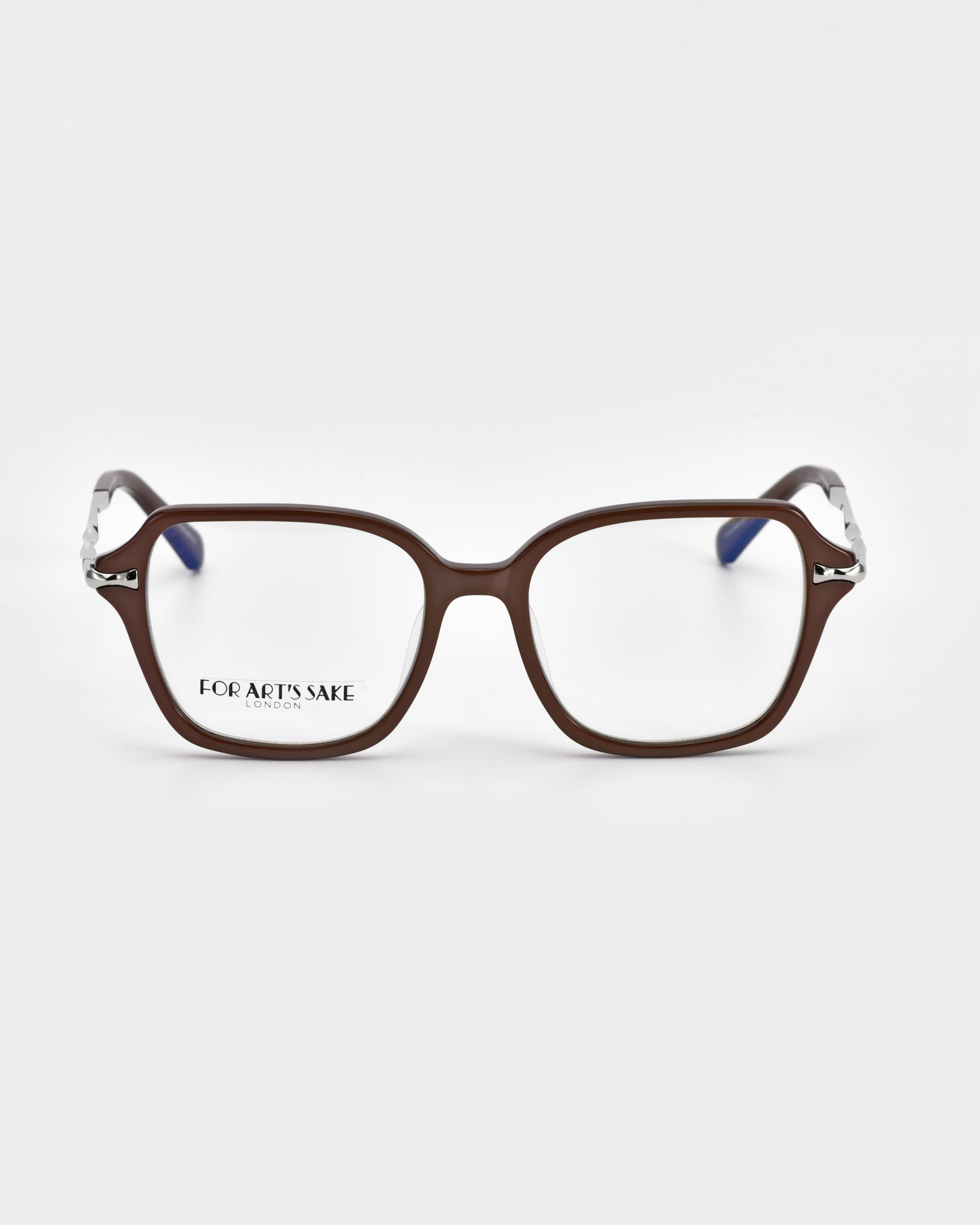 The Delight eyeglasses by For Art's Sake® exude modern sophistication with their rectangular lenses and brown frames. The arms feature a unique metal design near the hinges, transitioning to a darker color towards the ends. The brand name "For Art's Sake®" is visible on one lens against the white background.