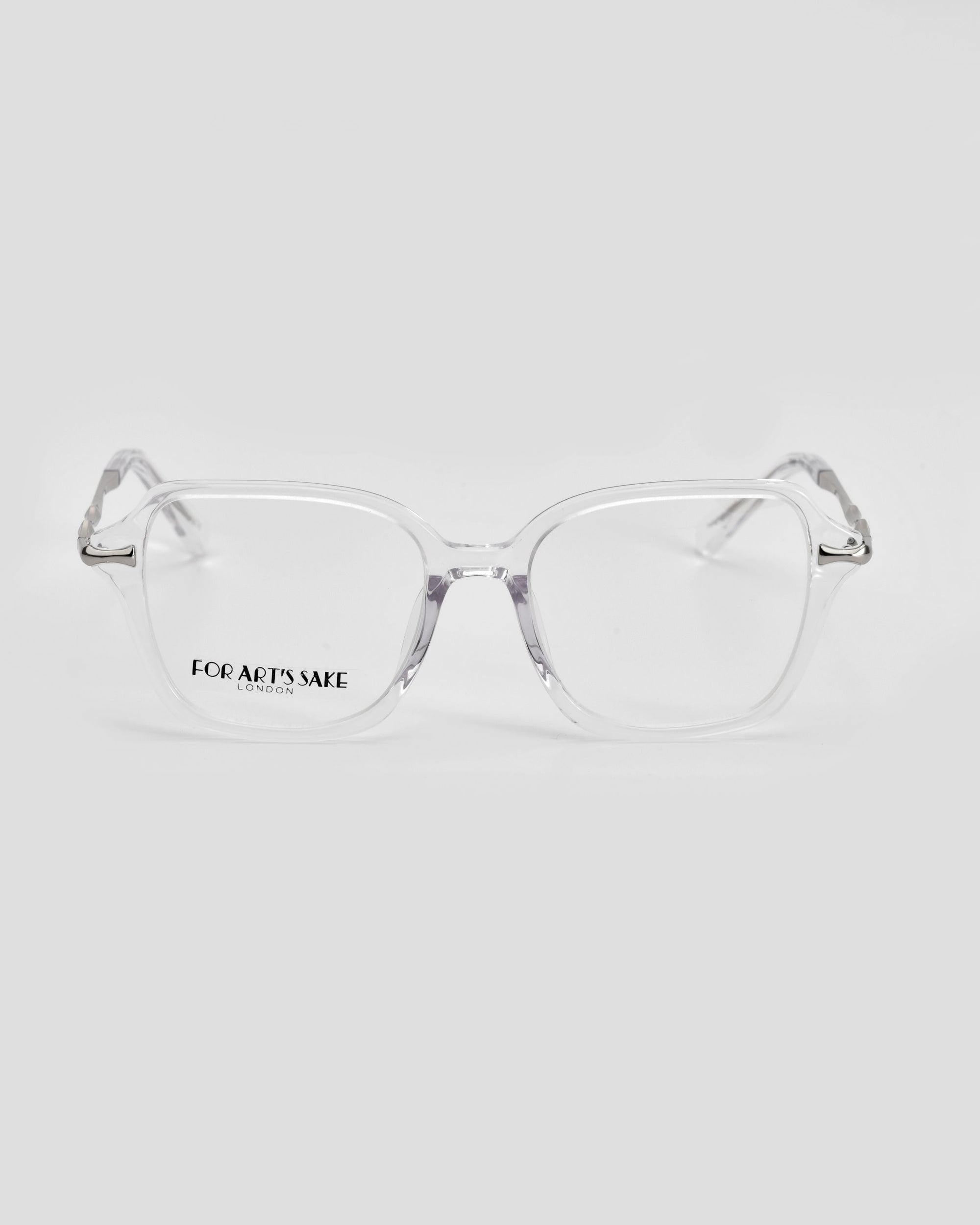 A pair of clear rectangular Delight eyeglasses from For Art's Sake®, showcasing the brand name "For Art's Sake® London" on one lens. The glasses emanate modern sophistication and are set against a plain white background.