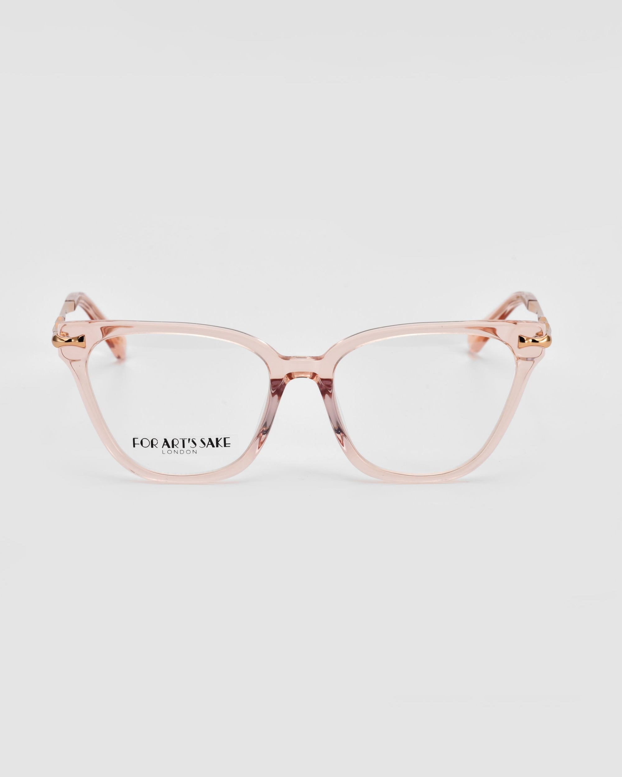 A pair of Lexie transparent light pink eyeglasses is displayed against a white background. Merging modern sophistication and vintage charm, these glasses feature rectangular frames with small gold accents at the temples. The brand name “For Art&#39;s Sake®” is visible on the left lens.