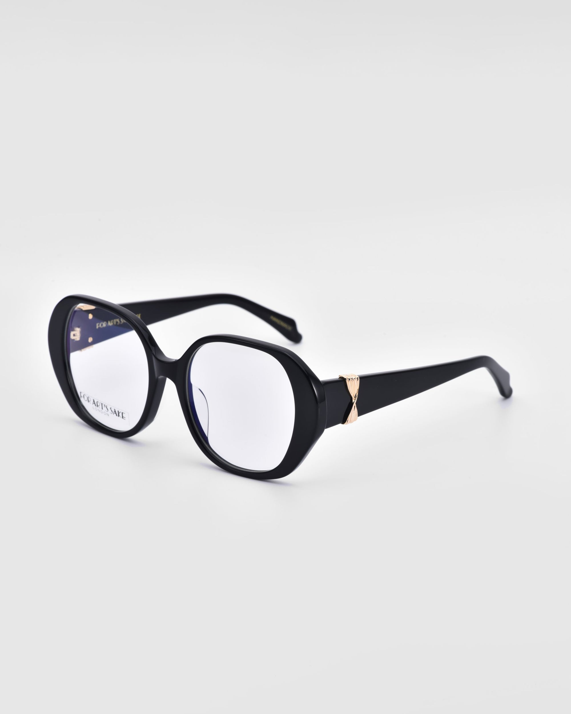 The For Art&#39;s Sake® &quot;Bow&quot; eyeglasses feature bold and stylish black frames with slightly rounded, oversized lenses. Each temple arm is accented with a subtle gold detail on the outer edge, and the frame is crafted from biodegradable acetate. The backdrop is a clean, solid white.