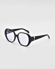 The For Art's Sake® "Bow" eyeglasses feature bold and stylish black frames with slightly rounded, oversized lenses. Each temple arm is accented with a subtle gold detail on the outer edge, and the frame is crafted from biodegradable acetate. The backdrop is a clean, solid white.