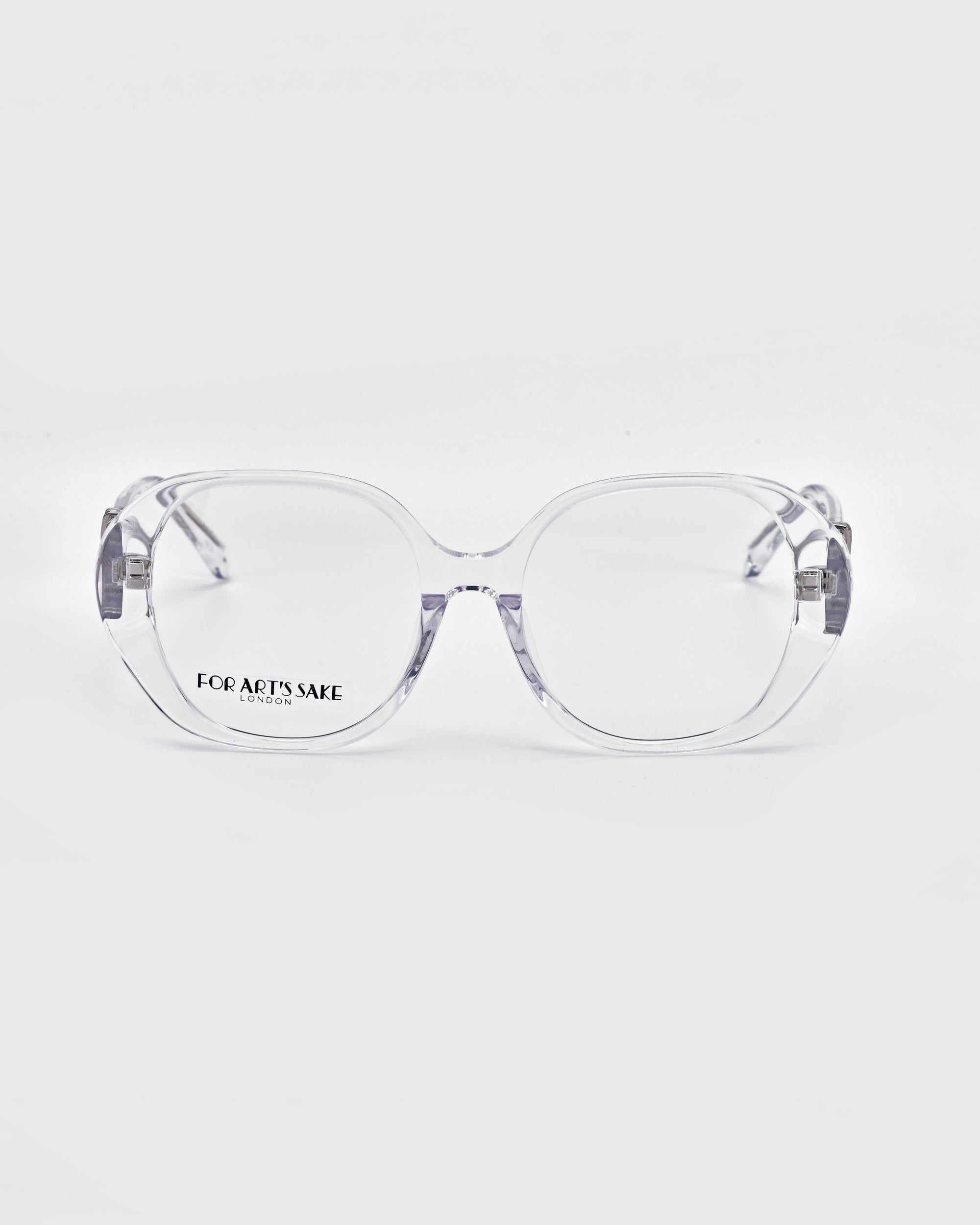 The Bow glasses from For Art&#39;s Sake® feature a transparent frame and oversized, rounded lenses, displayed against a plain white background. The left lens displays the words &quot;FOR ART&#39;S SAKE,&quot; while the arms showcase a minimalistic design.