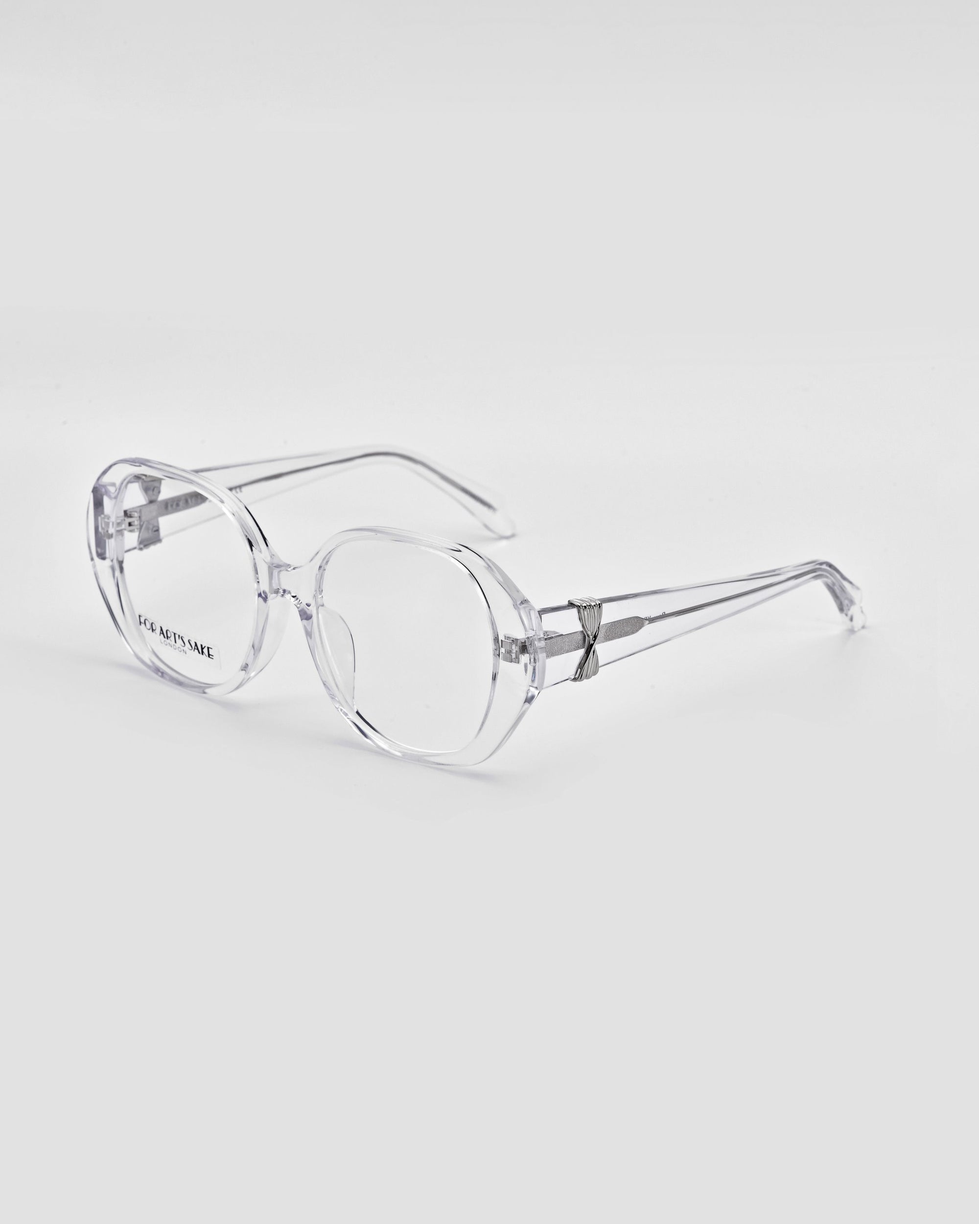 A pair of bold and stylish glasses with clear, oversized lenses and an oval frame design placed on a white background. The arms are also clear, and the brand name &quot;For Art&#39;s Sake®&quot; is subtly visible on the lens. The Bow glasses have a modern, minimalist aesthetic.