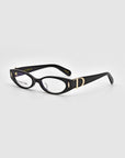 The Cigar eyeglasses by For Art's Sake® are a pair of stylish black frames with a sleek design, featuring small circular cutouts near the hinges and golden accents on the polished acetate temples. The lenses have a slightly oval shape, evoking vintage charm, while the interior of the arms is embossed with brand information.