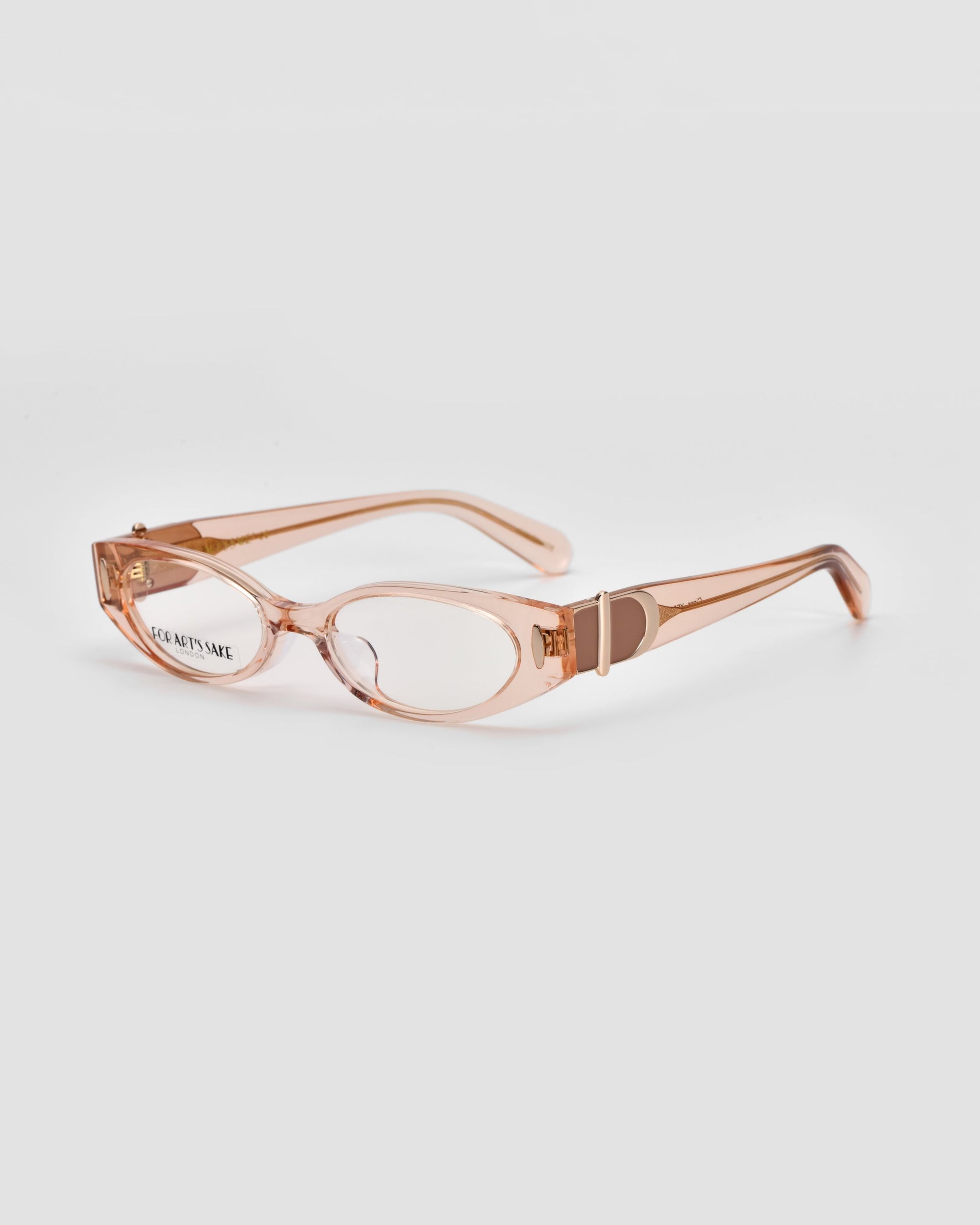 A pair of For Art&#39;s Sake® Cigar glasses in light pink with transparent clear lenses. The frames showcase a sleek, angular design that exudes vintage charm, complemented by polished acetate temples that gradually widen from the front to the ear pieces. The glasses are displayed on a plain white background.