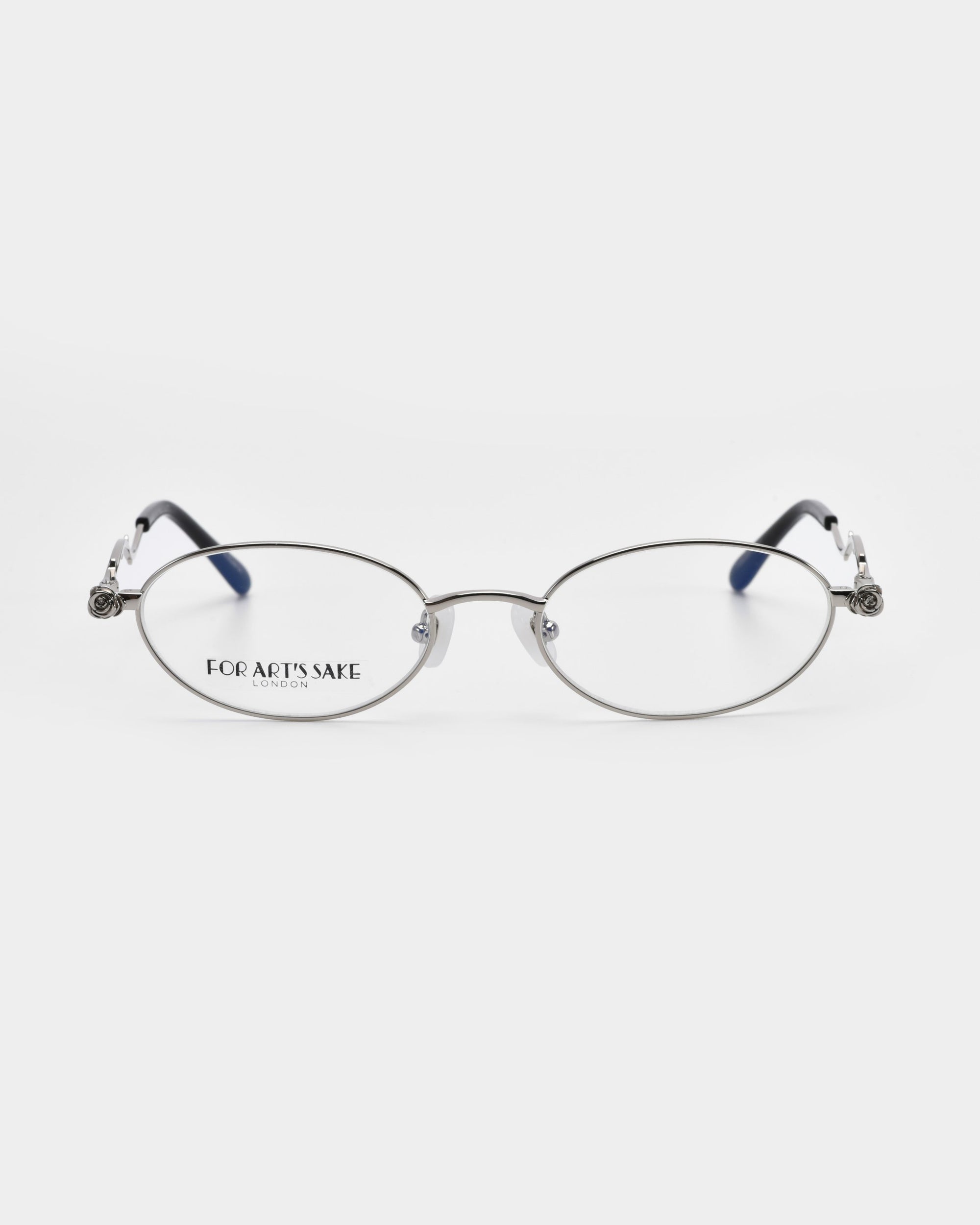 The "Thorn" optical glasses by For Art's Sake® feature oval-shaped lenses with thin metal frames and dark temple tips, showcasing artistic flair. The brand name is visible on one lens against a plain white background.