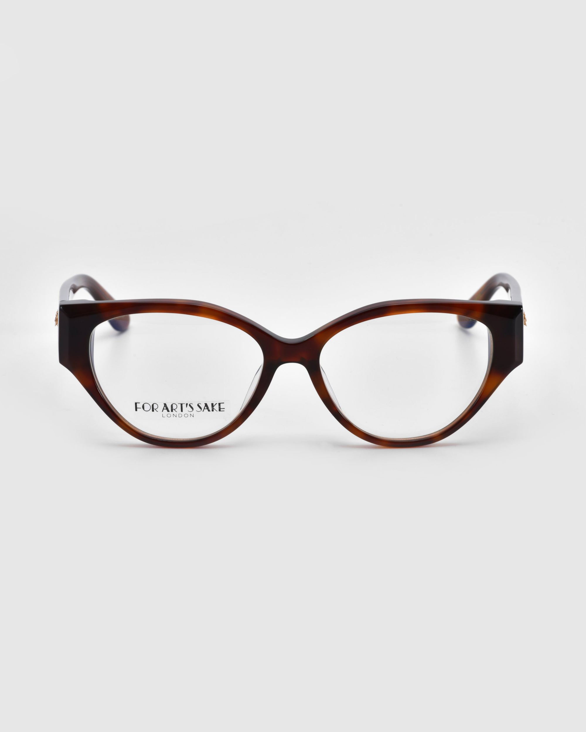 A pair of tortoiseshell cat-eye glasses with thick frames from the Rosalia I collection is on a white background. The subtle For Art's Sake® logo on the inside of the left lens embodies sophistication and femininity.