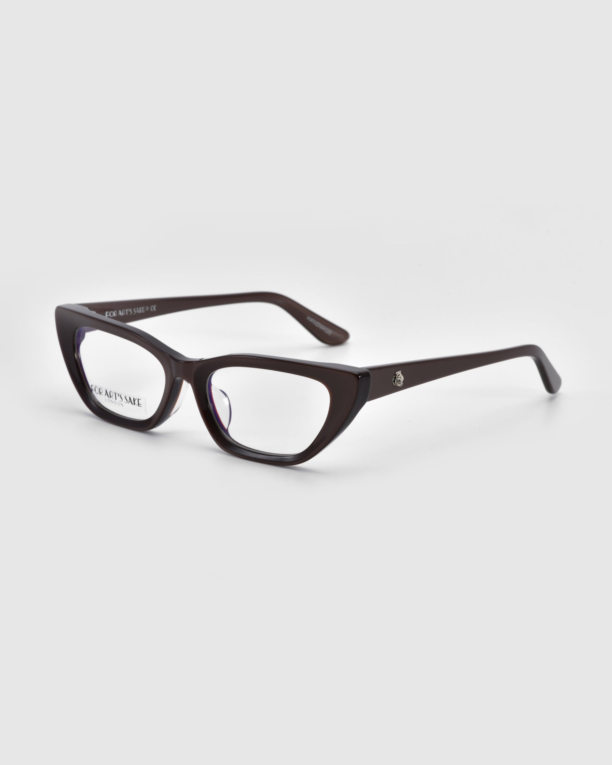 The Rosalia II by For Art's Sake® features black-rimmed, slightly angular frames from the Rose Garden Collection, resting on a white surface. With clear lenses and sleek arms adorned with a logo, its modern and stylish design exudes subtle femininity.